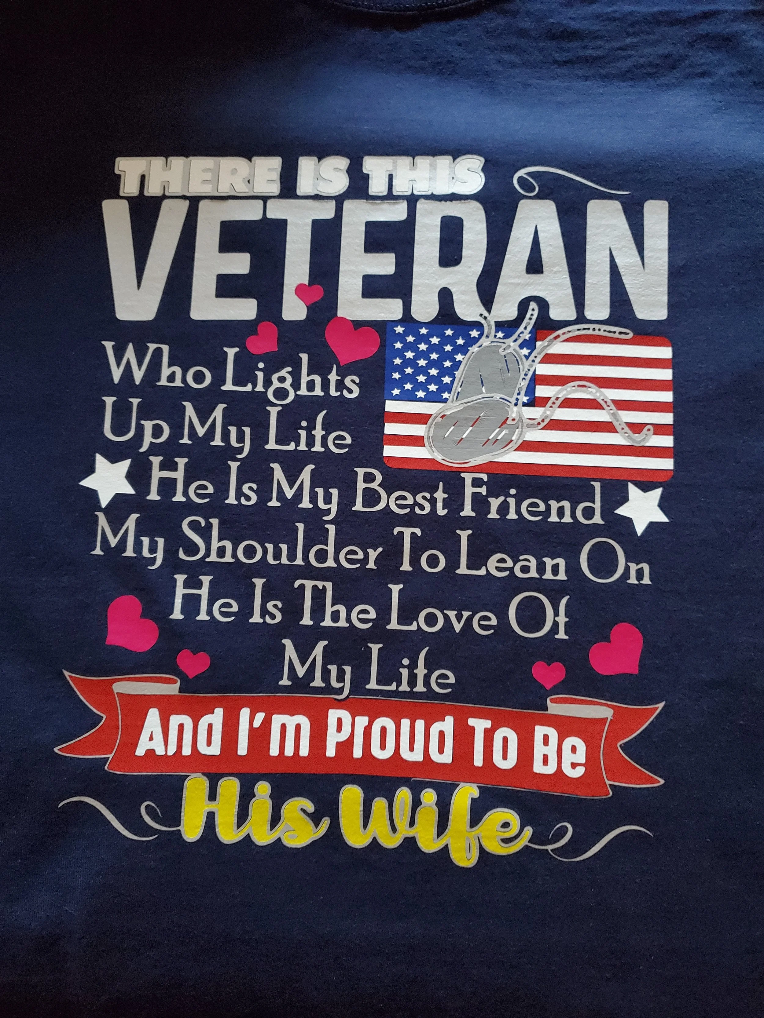 Text on a dark blue background with decorative stars and hearts. The text reads: "There is this veteran who lights up my life. He is my best friend. My shoulder to lean on. He is the love of my life. And I'm proud to be his wife." A small American fl