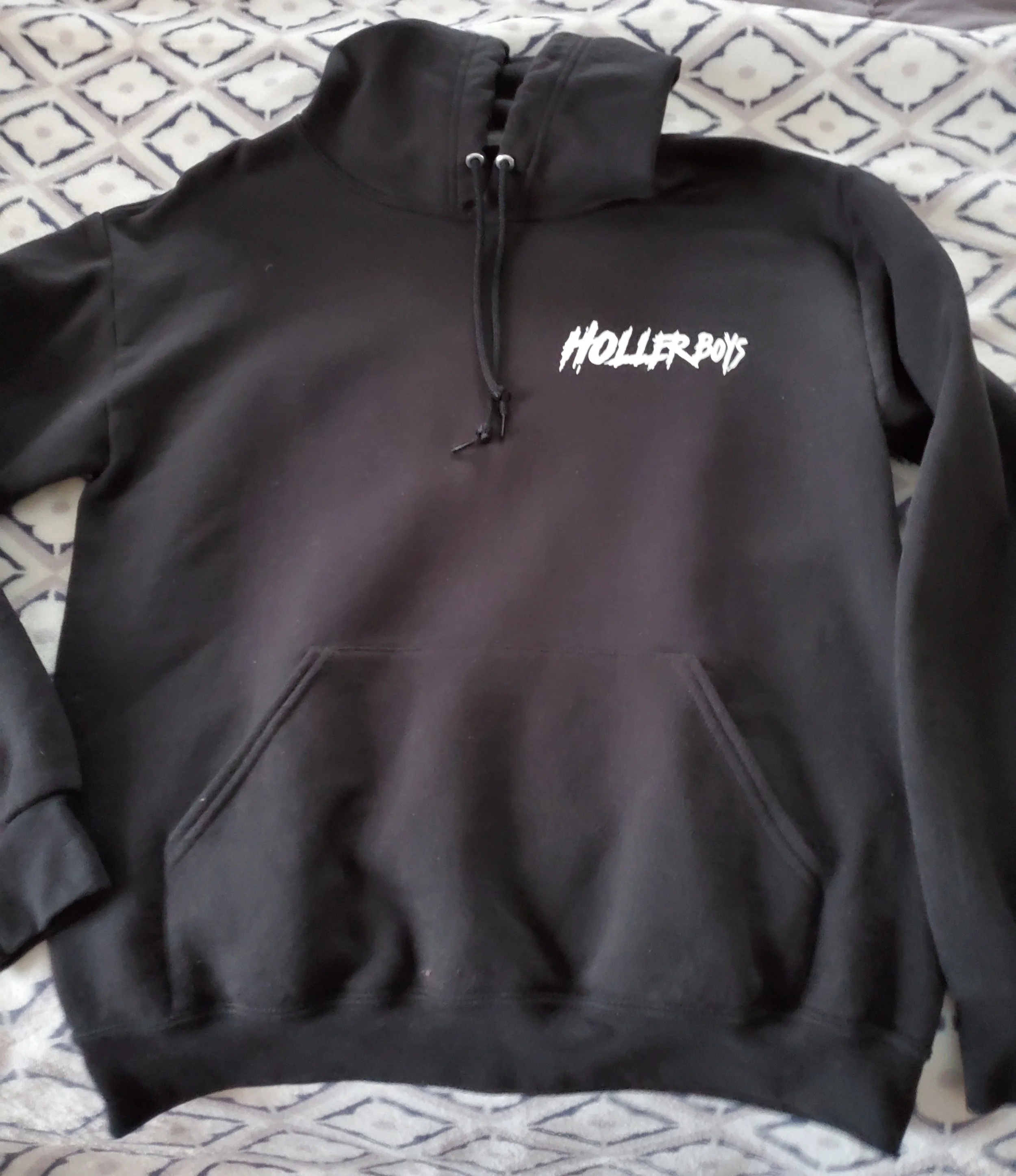 Black hoodie with drawstrings and a front pocket, featuring a white logo that says 'Holler Boys' on the chest.