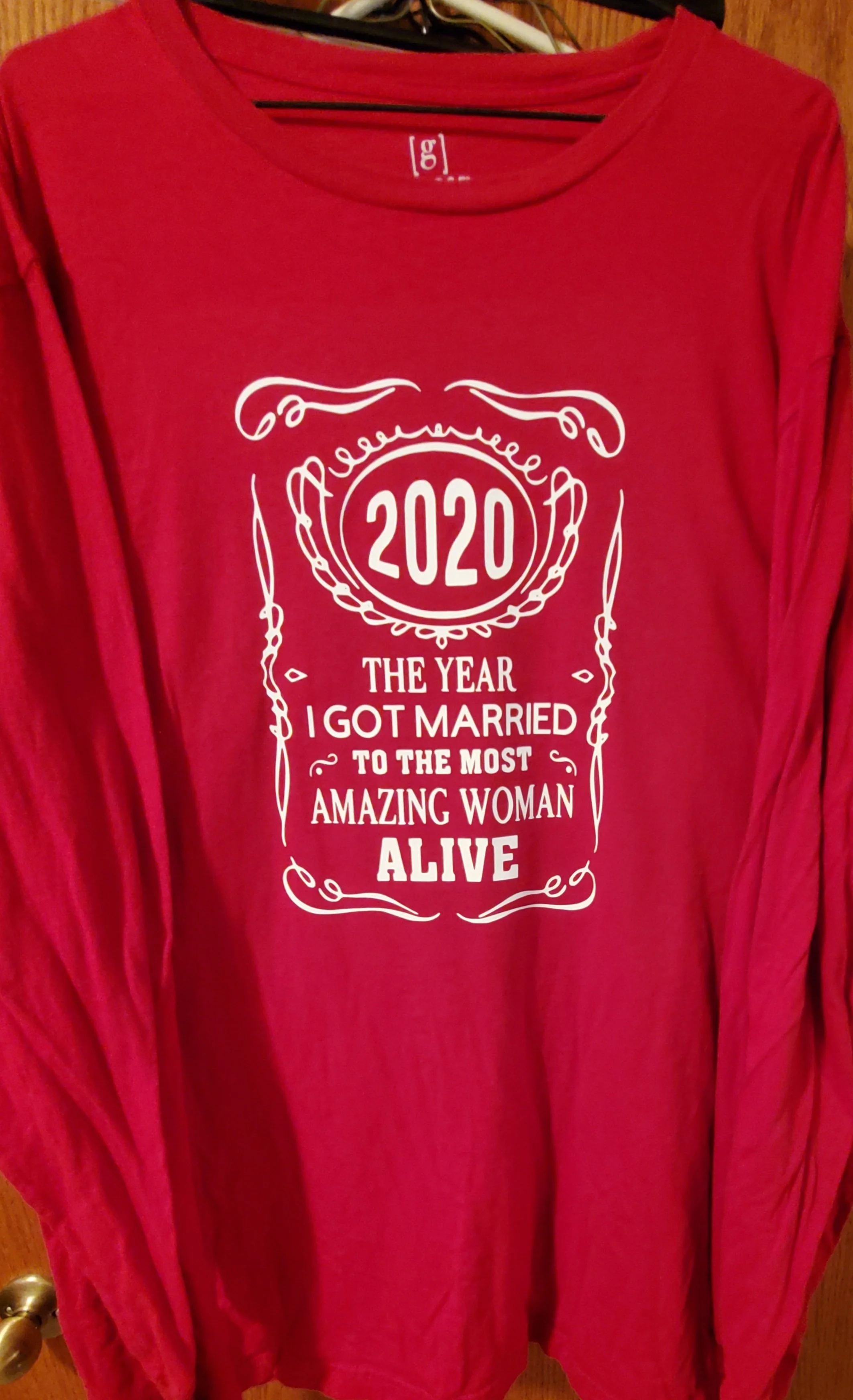 Red T-shirt with white printed text that reads, '2020 THE YEAR I GOT MARRIED TO THE MOST AMAZING WOMAN ALIVE.'