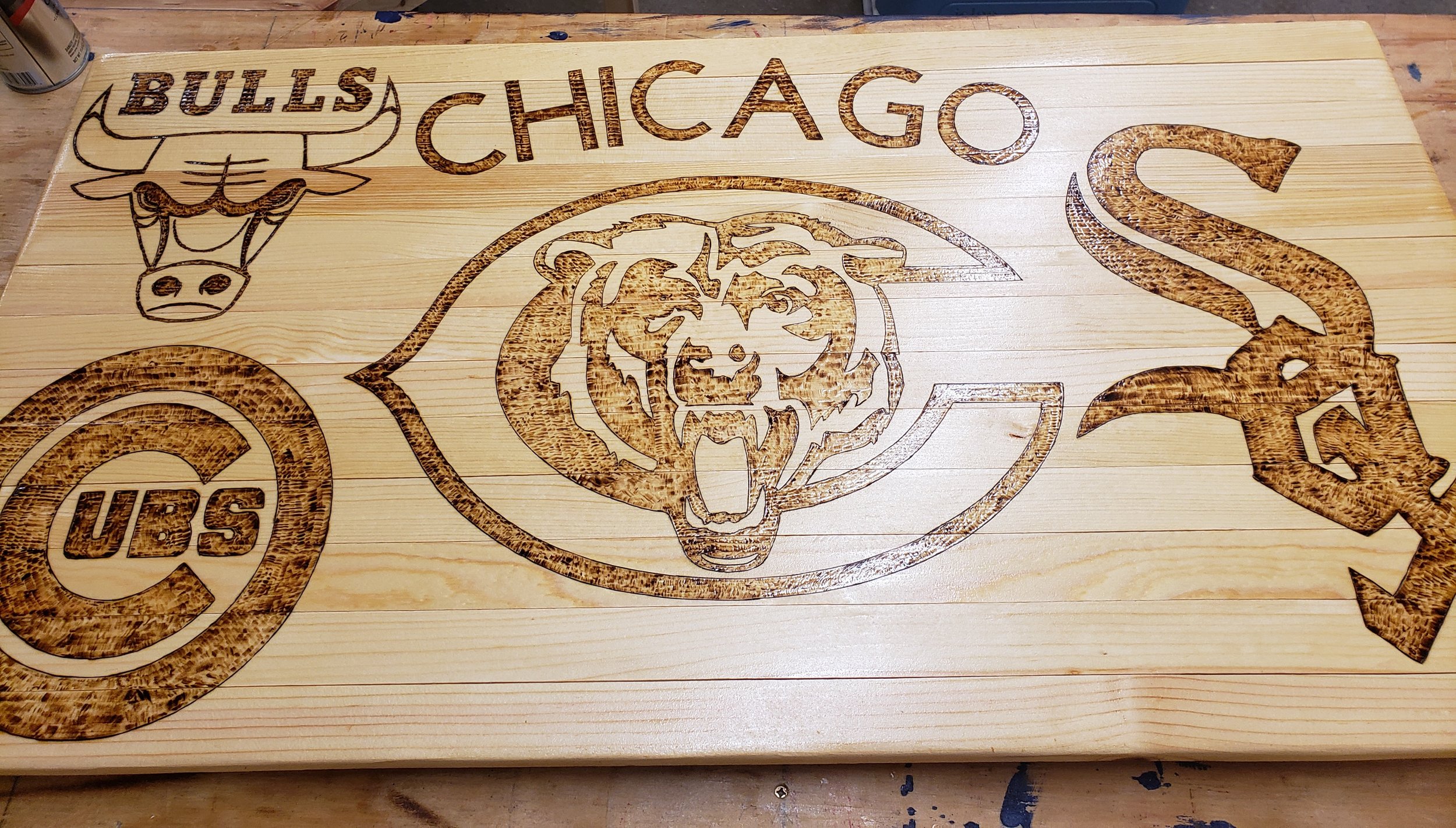 Wooden plaque with laser-engraved logos and text for the Chicago Bears, Buffalo Bills, and Tampa Bay Buccaneers.