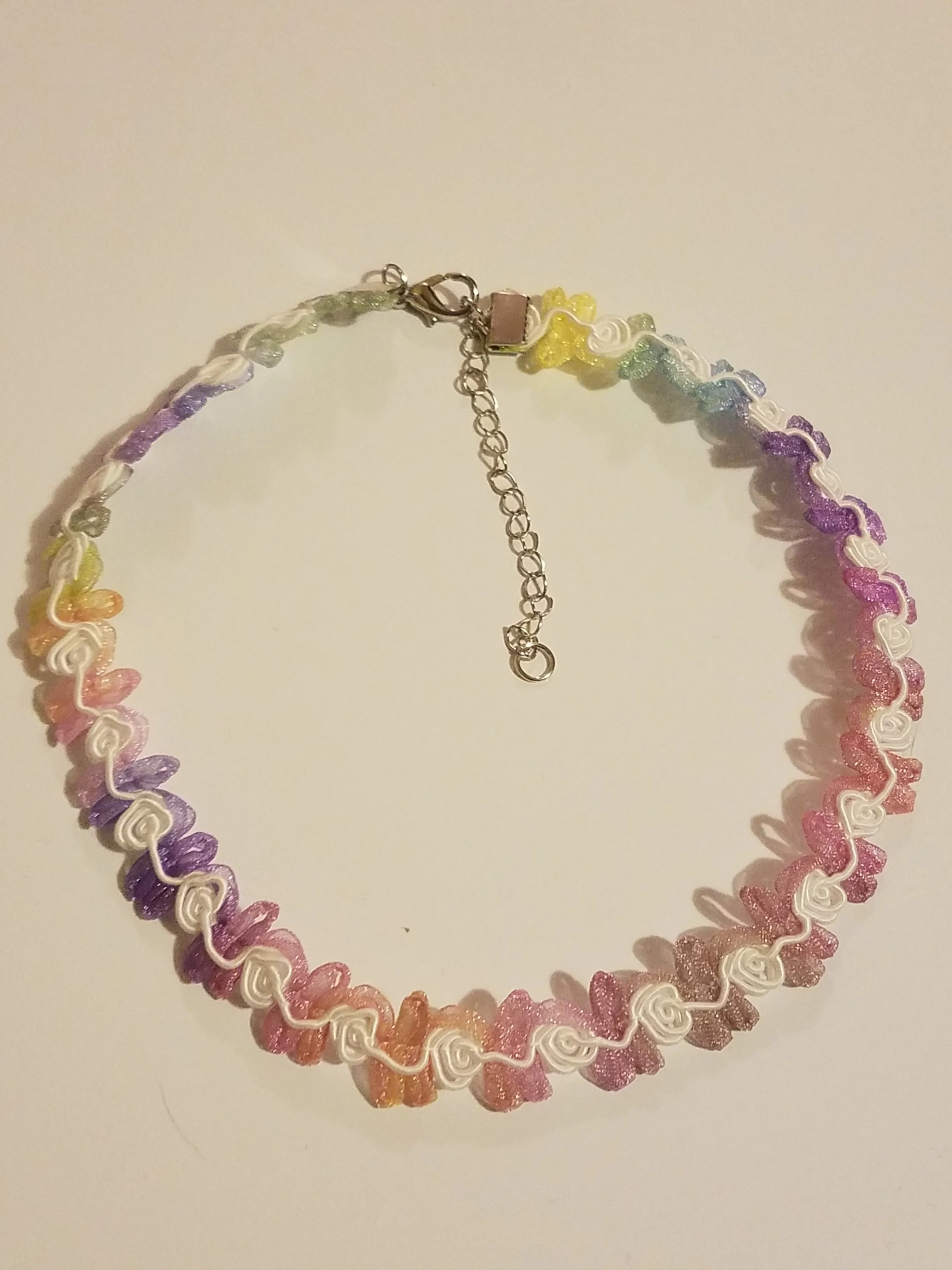 Colorful rainbow-themed embroidered choker necklace with an adjustable chain on a white background.