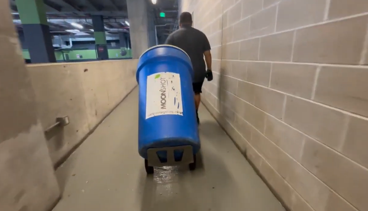 Moonshot Compost employee replacing drum