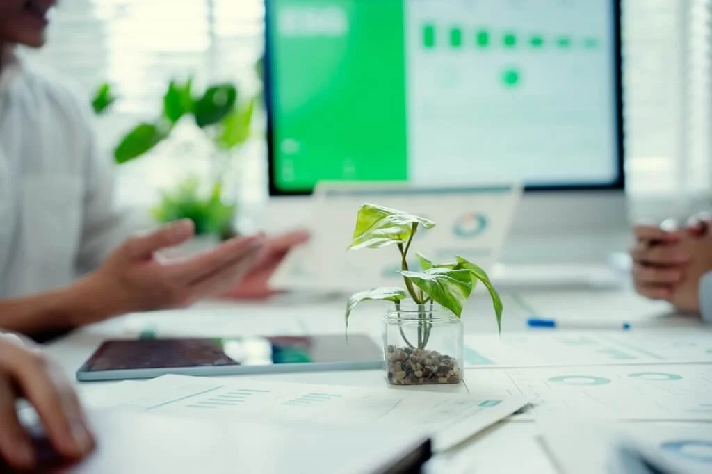 Business meeting analyzing sustainability performance