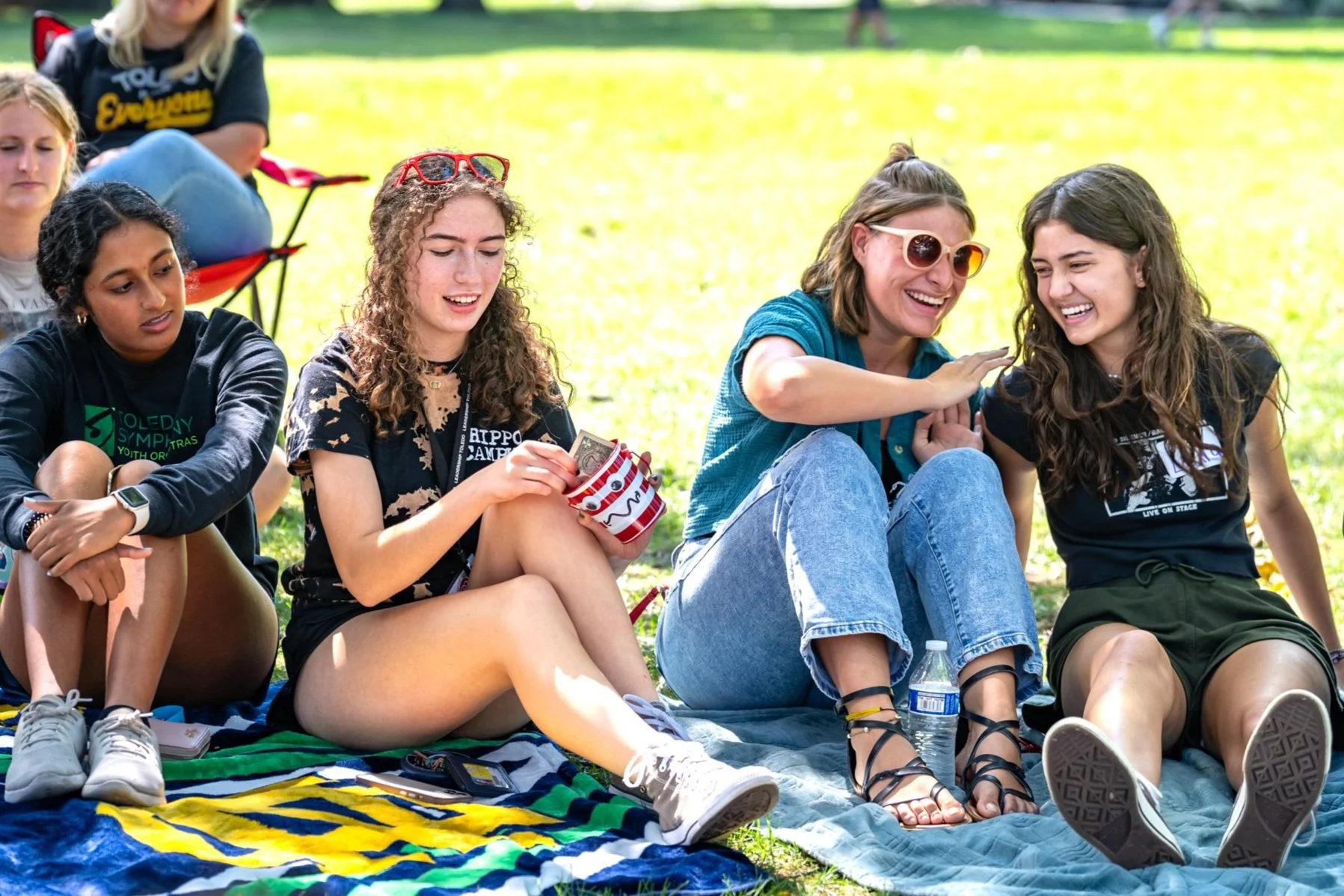 YIPEE teens sit together on a picnic blanket