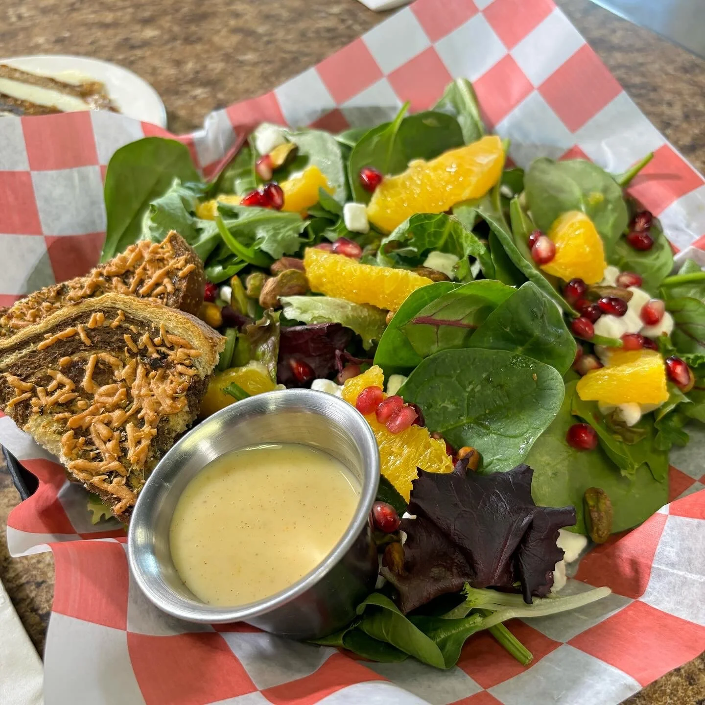 Fresh salad with fruit and cheesy garlic bread