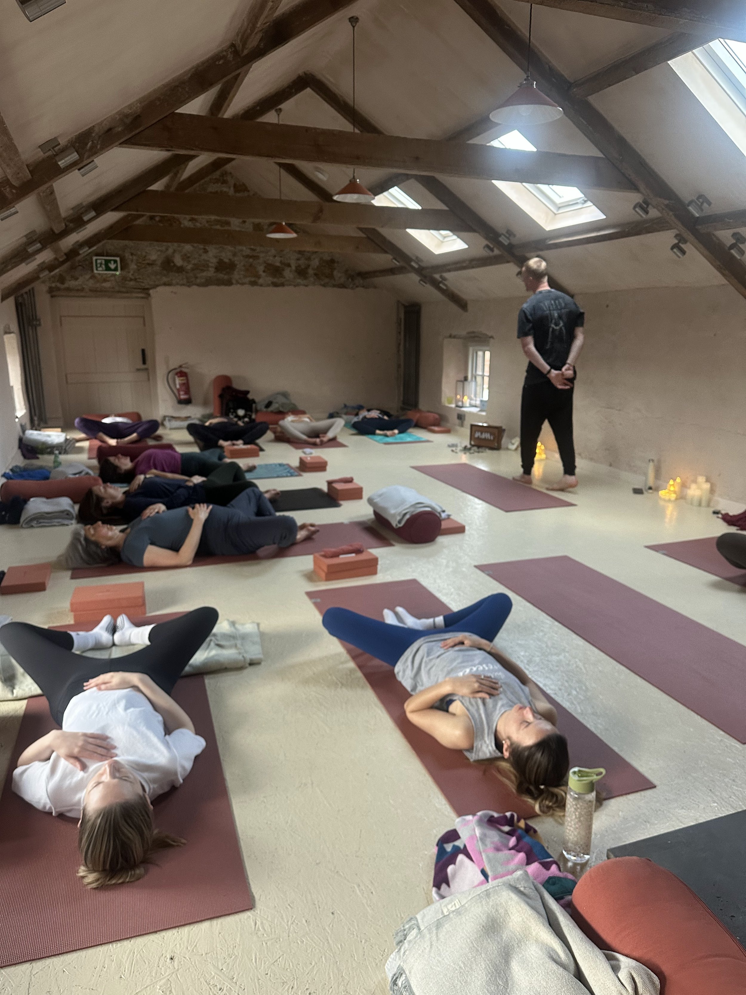 male teacher leading retreat yoga class
