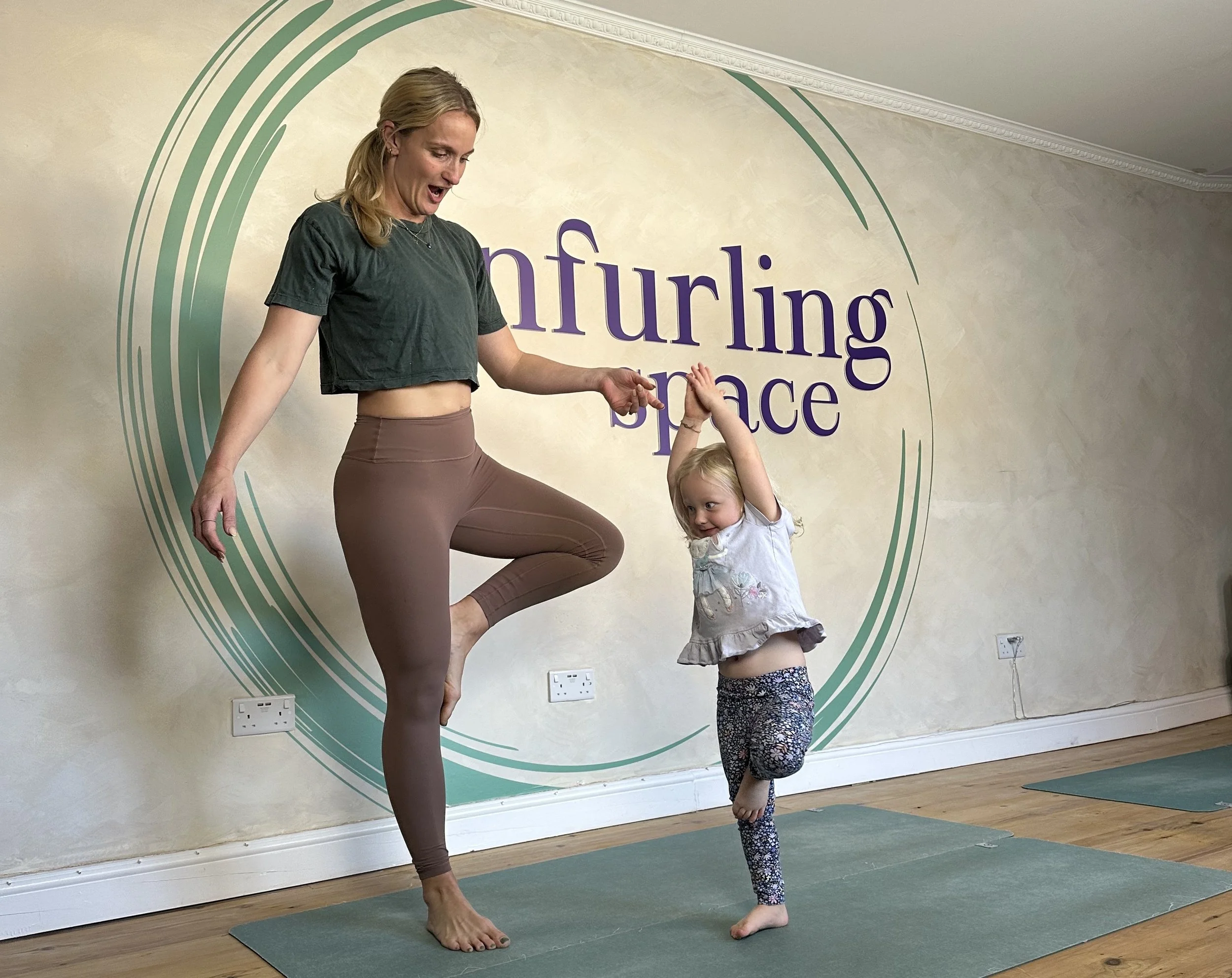 yoga teacher and child practicing yoga