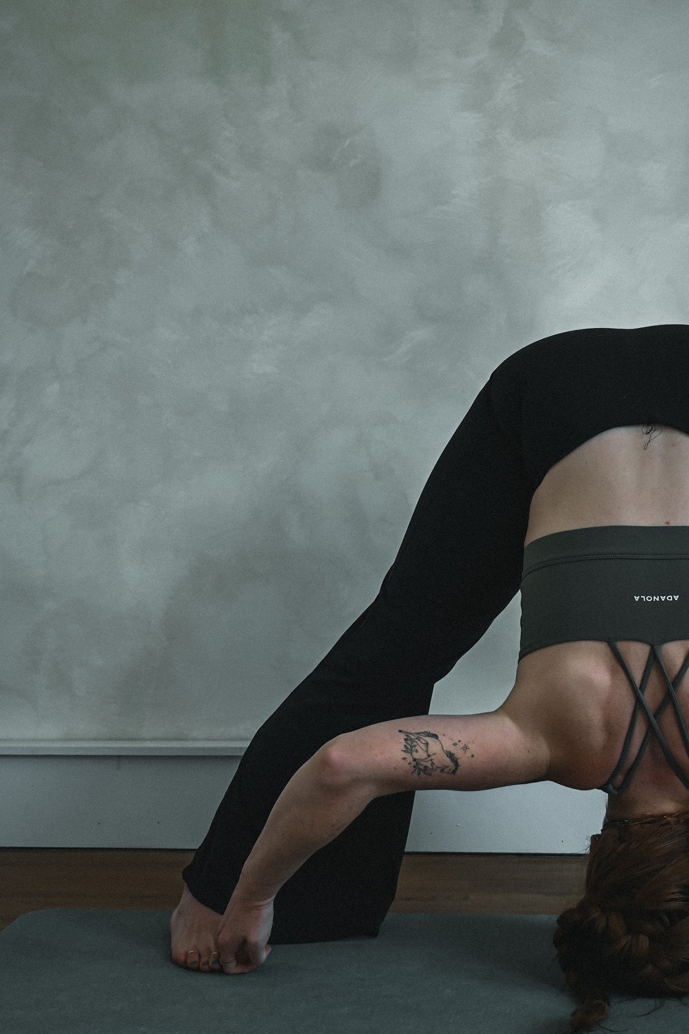 woman in bound wide legged forward fold yoga