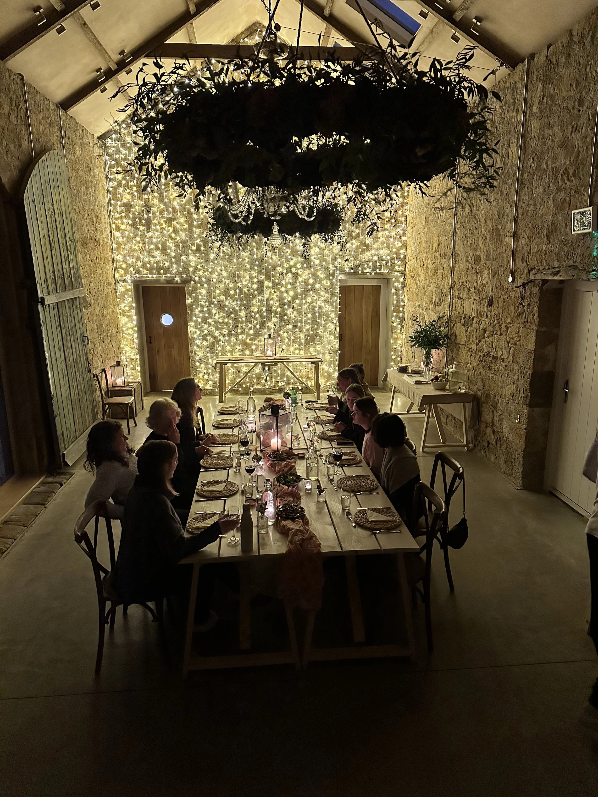 retreat dining table with guests in fairy light