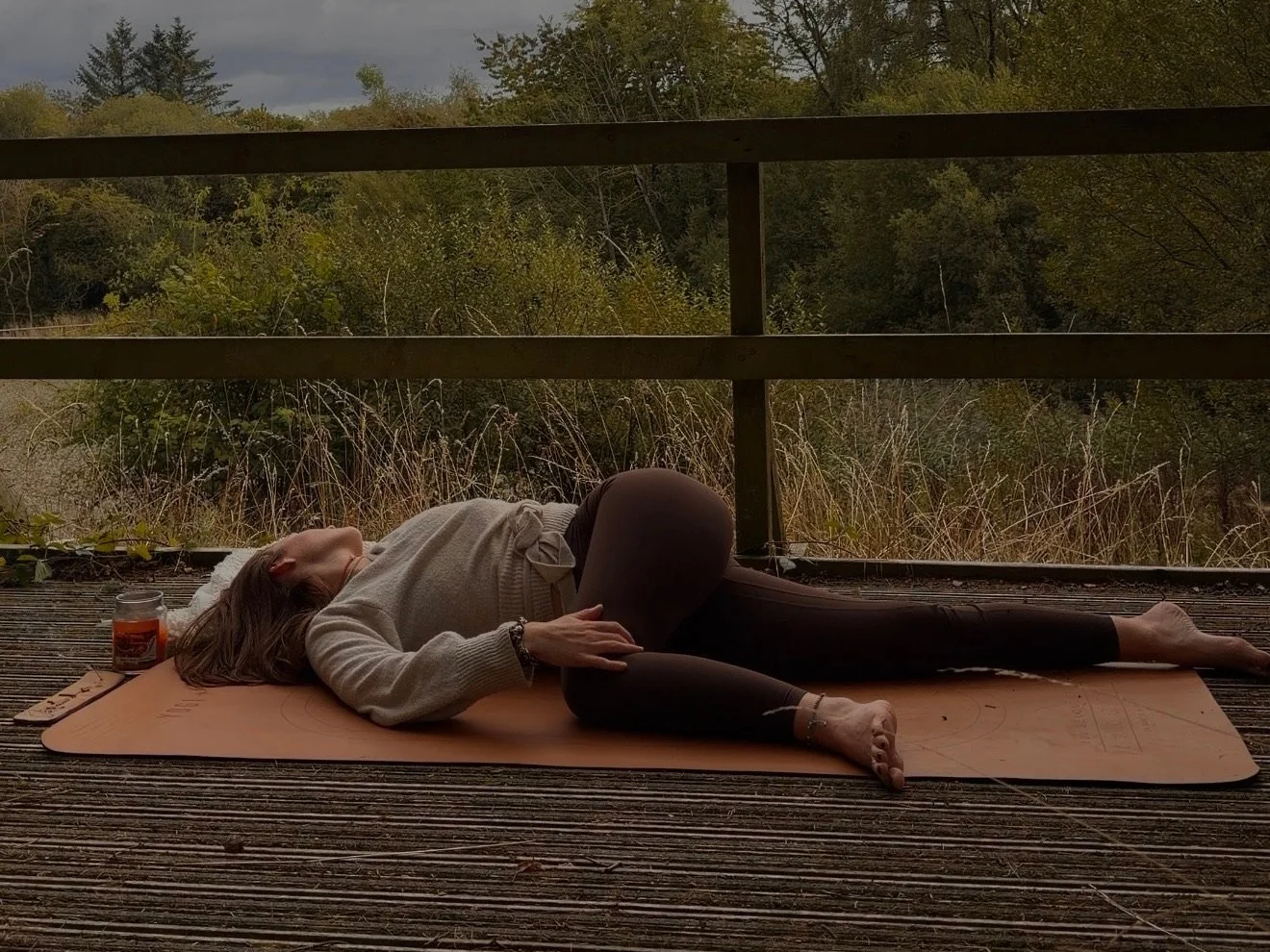 woman in yoga pose in autumnal setting
