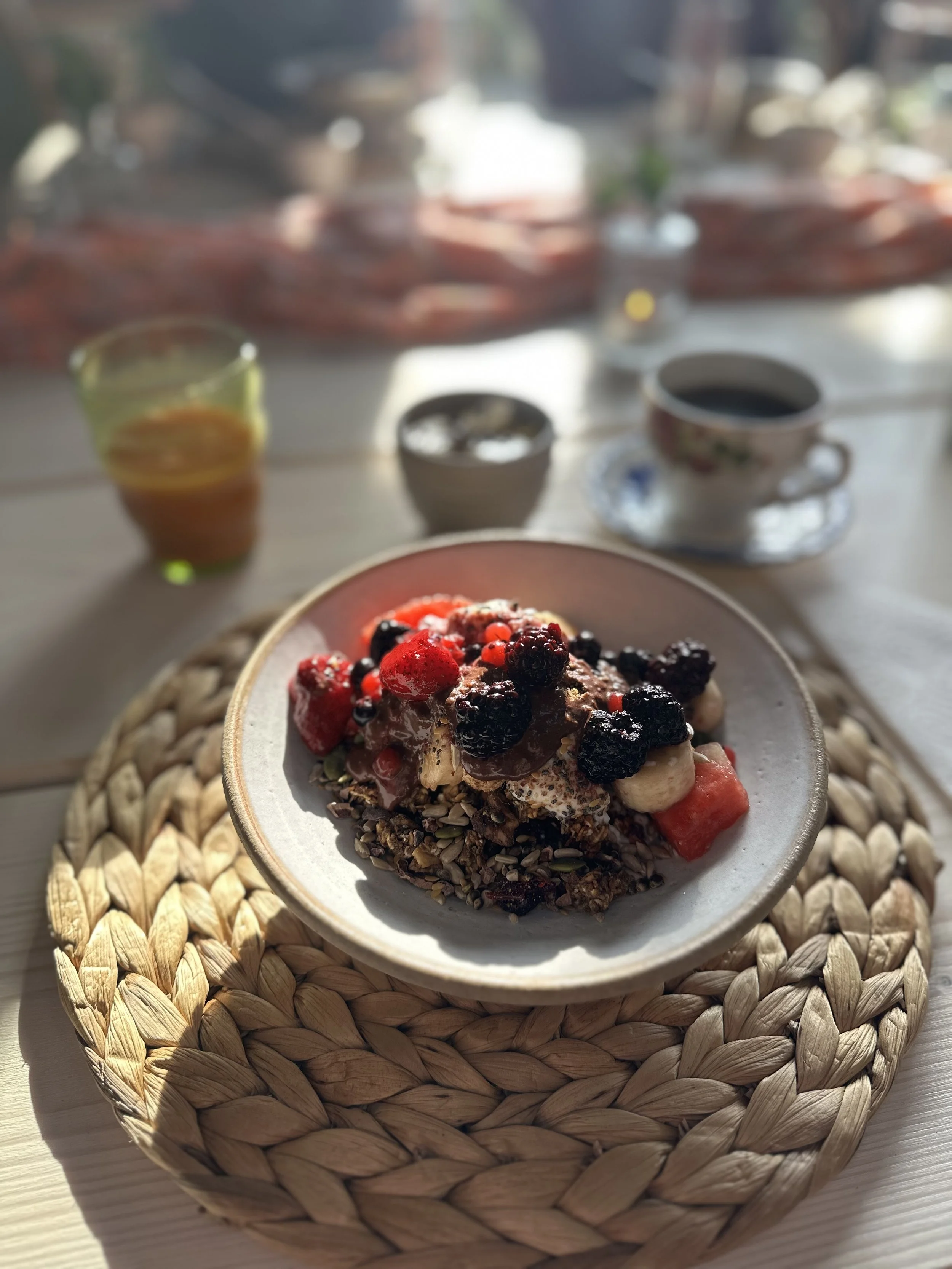 healthy homemade granola with fruit compote and superfood toppings