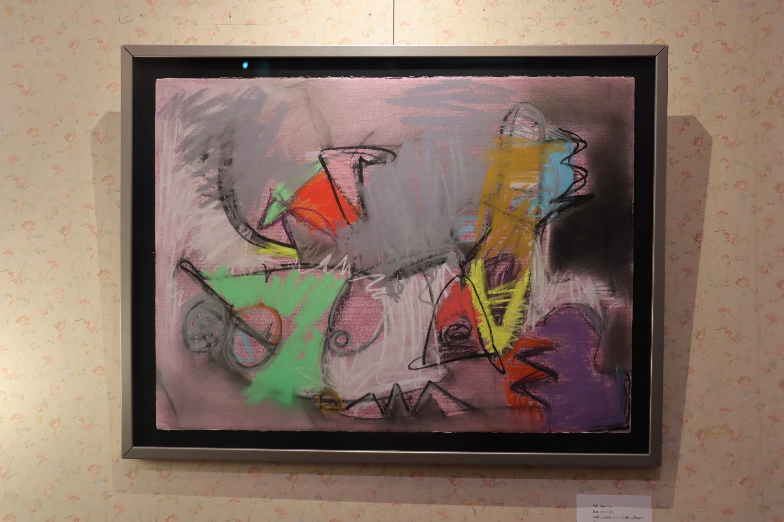 Abstract artwork featuring colorful, loose line drawings of various objects, including a glass, a bottle, and a cone, on a pink background.