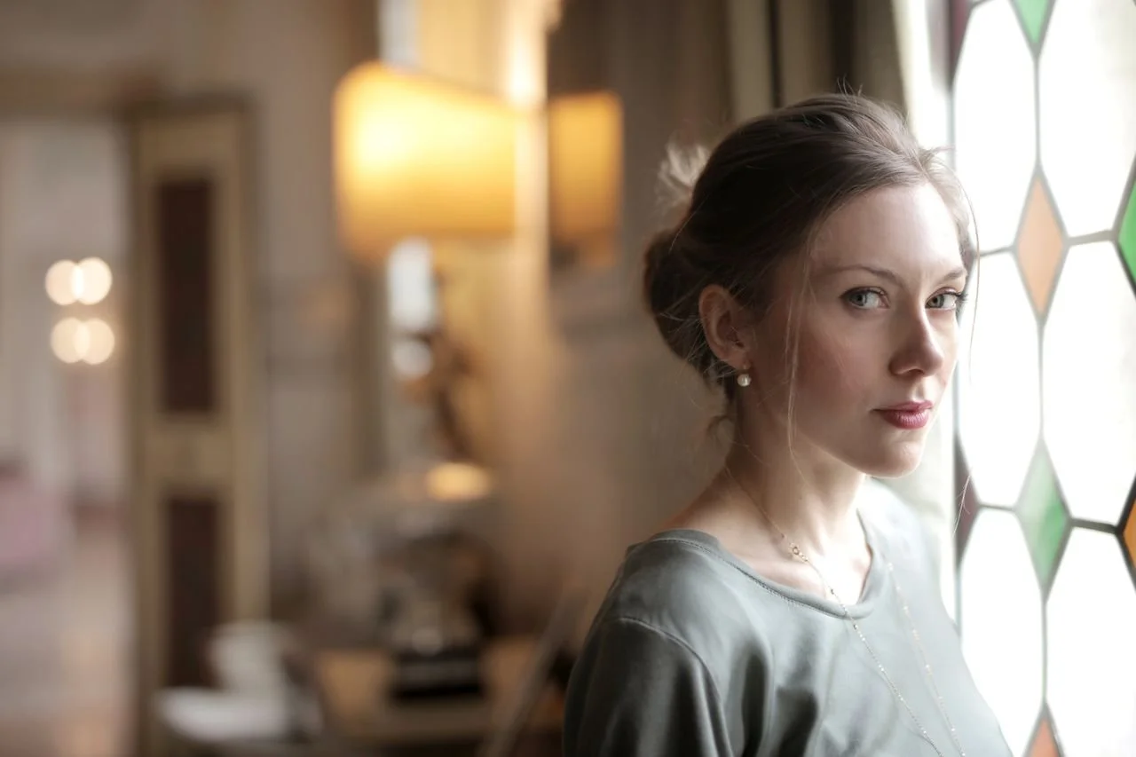 woman-in-luxury-room-near-window-on-sunny-da
