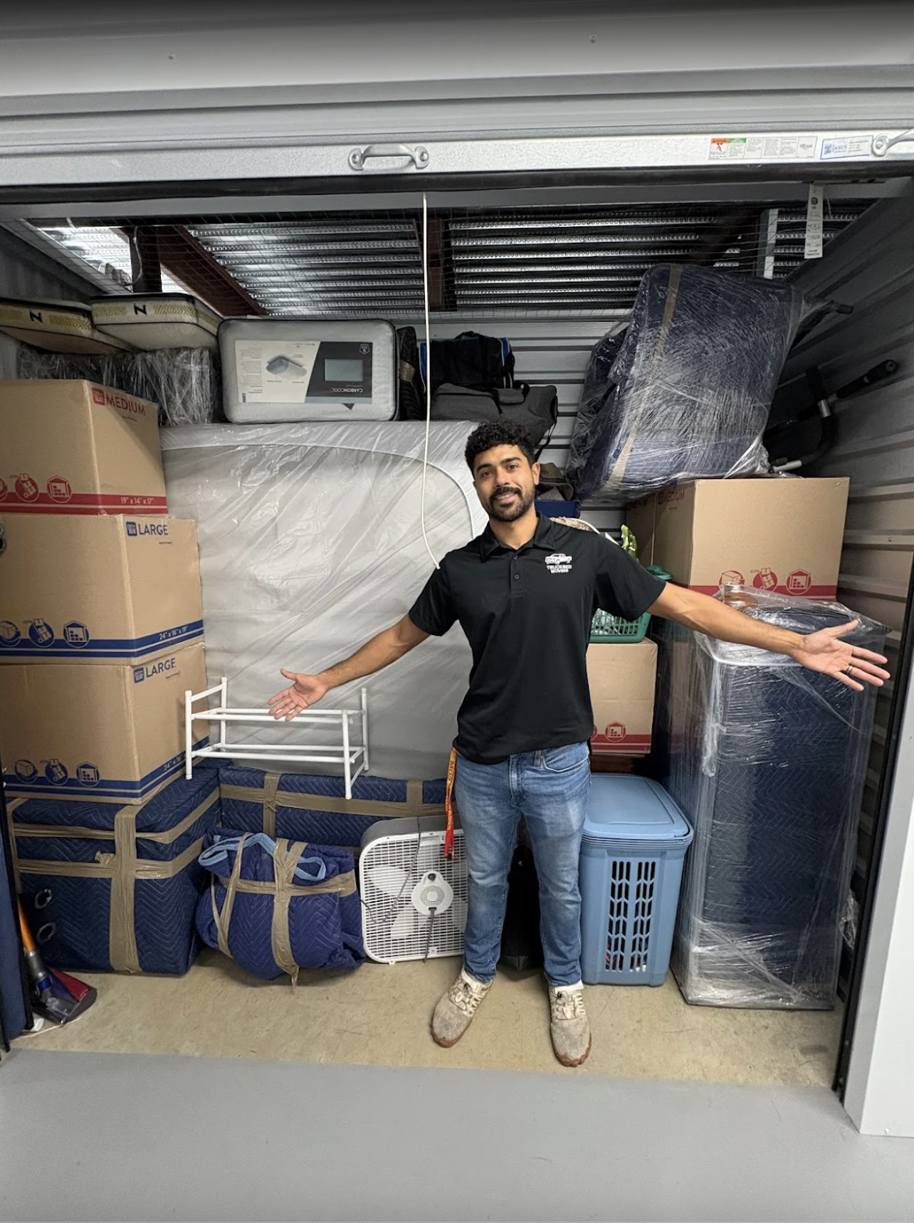 alt="mover moves boxes and furniture from old to new storage unit""