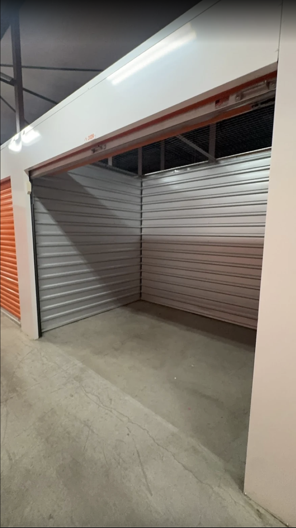 alt="movers unloaded a public storage unit into moving truck""