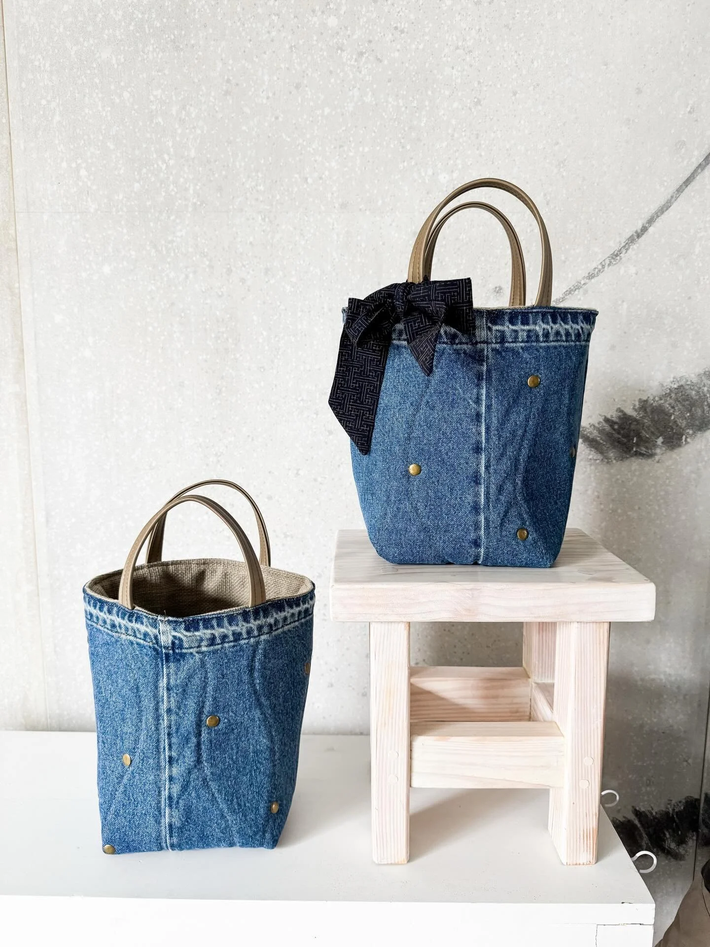 We&rsquo;ve got twins! These two up-cycled denim &ldquo;Janette&rdquo; bags are hand quilted and adorned with bronze rivets to match the vegan leather handles.

They each have a double Levi&rsquo;s pocket on the inside and a neutral woven upholstery 