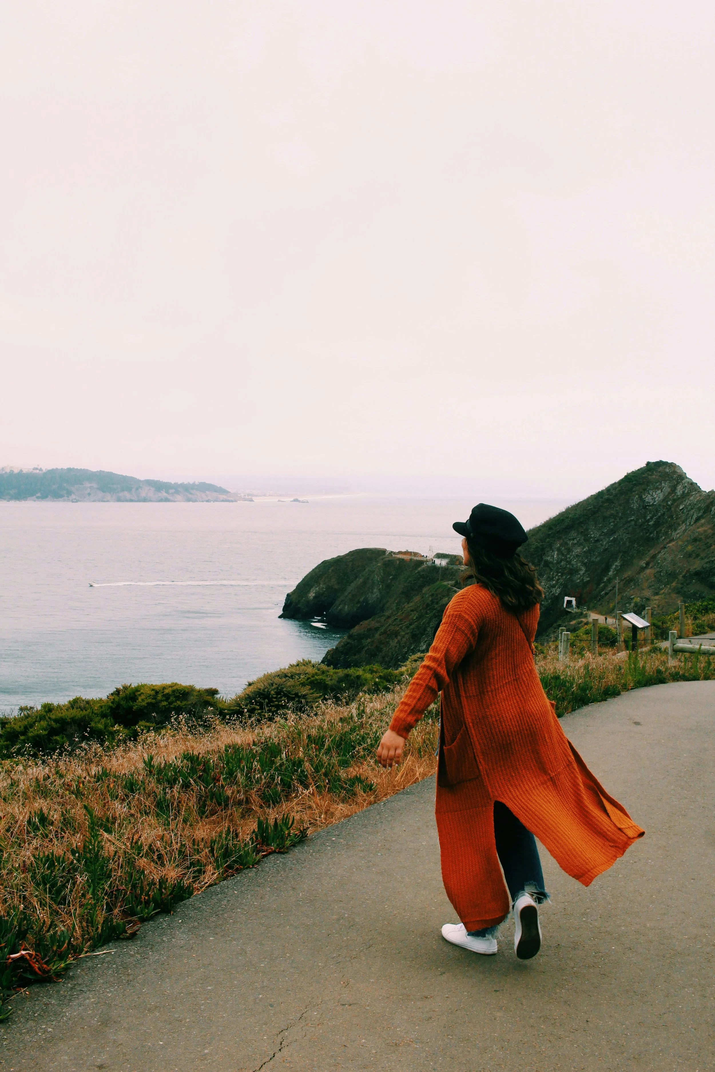 woman in California peninsula with her arms out like she is releasing the negative energy after receiving therapy virtually.