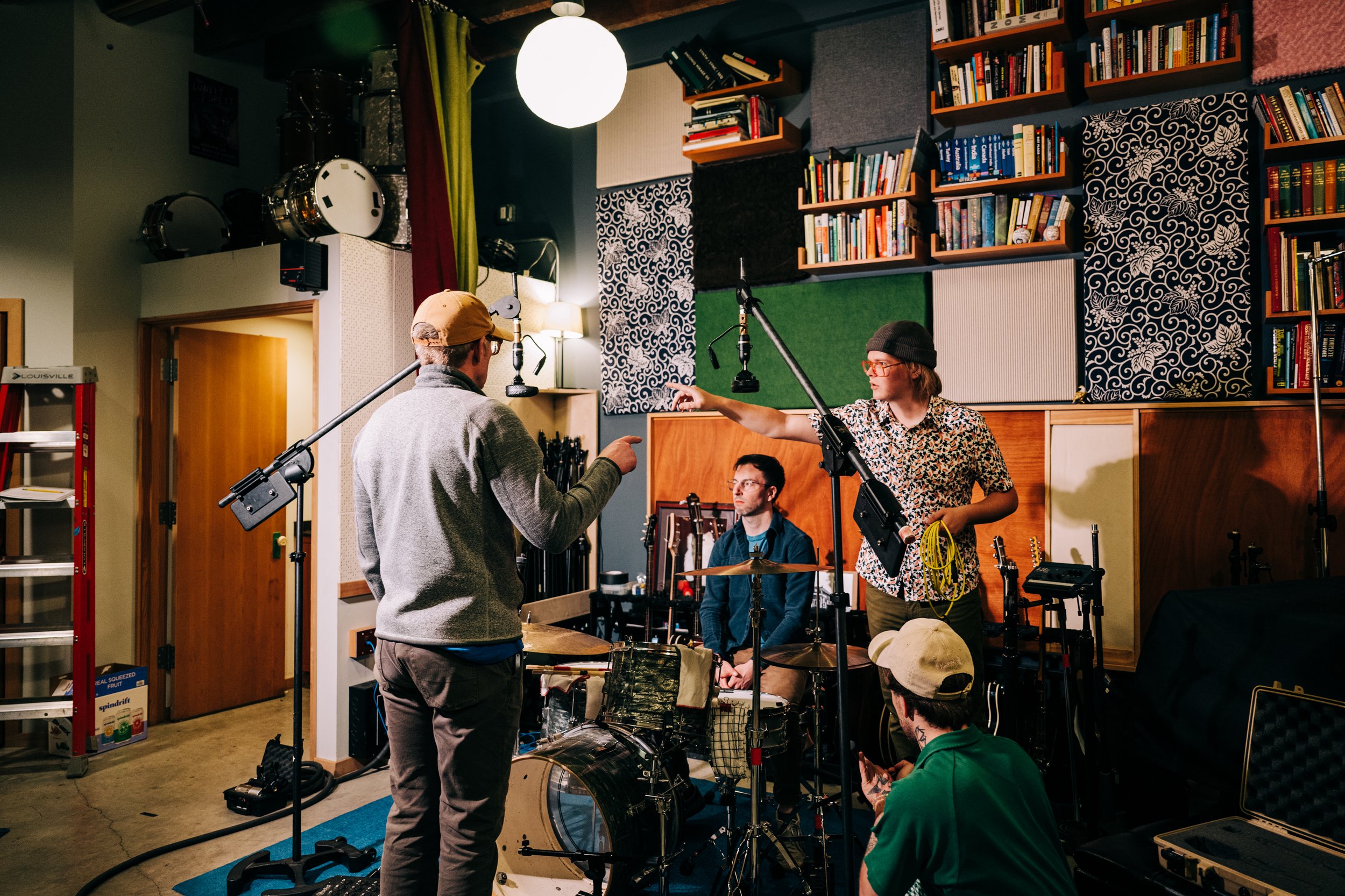 Students and teacher setting to record drums