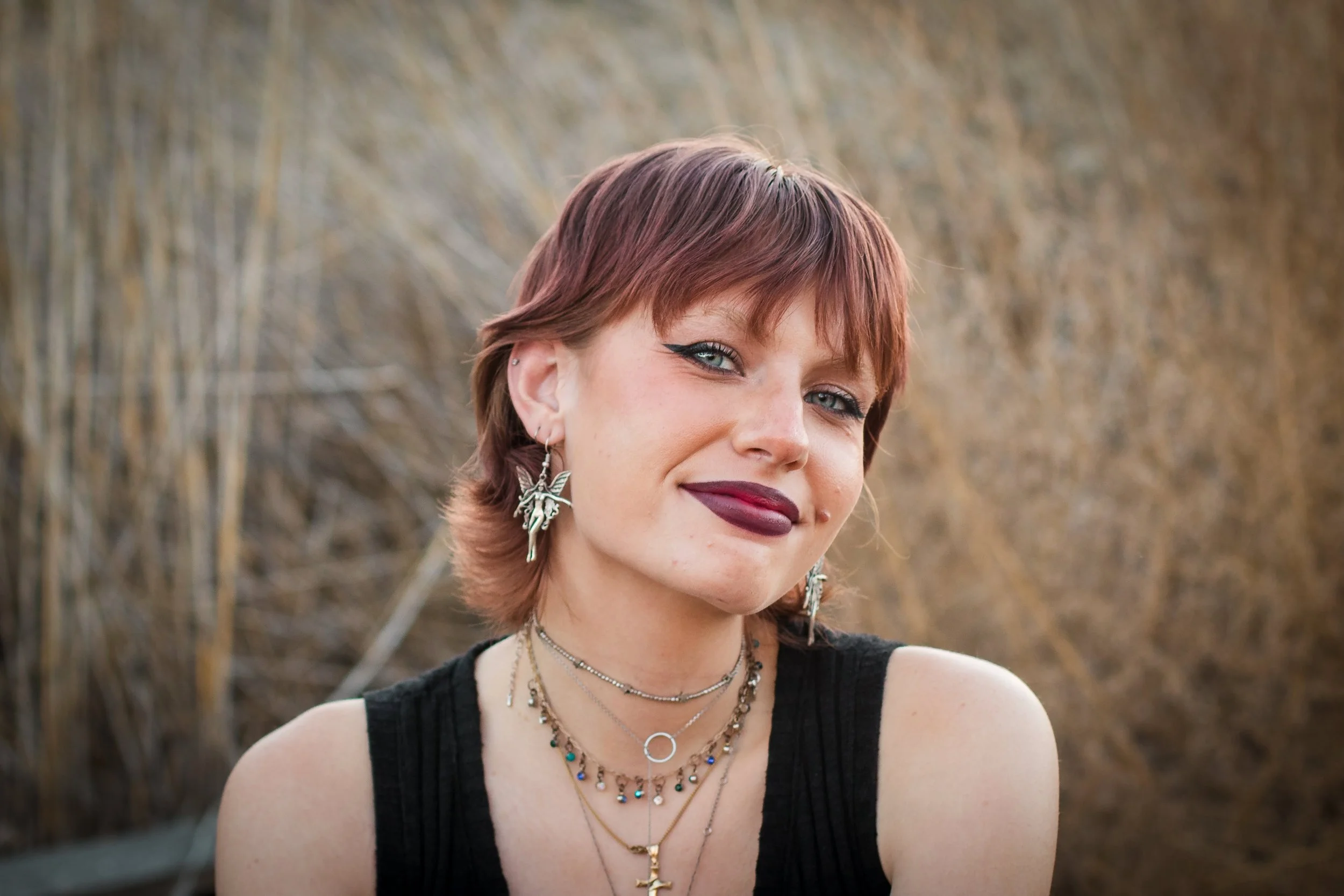 A smiling young woman who feels happier with life.