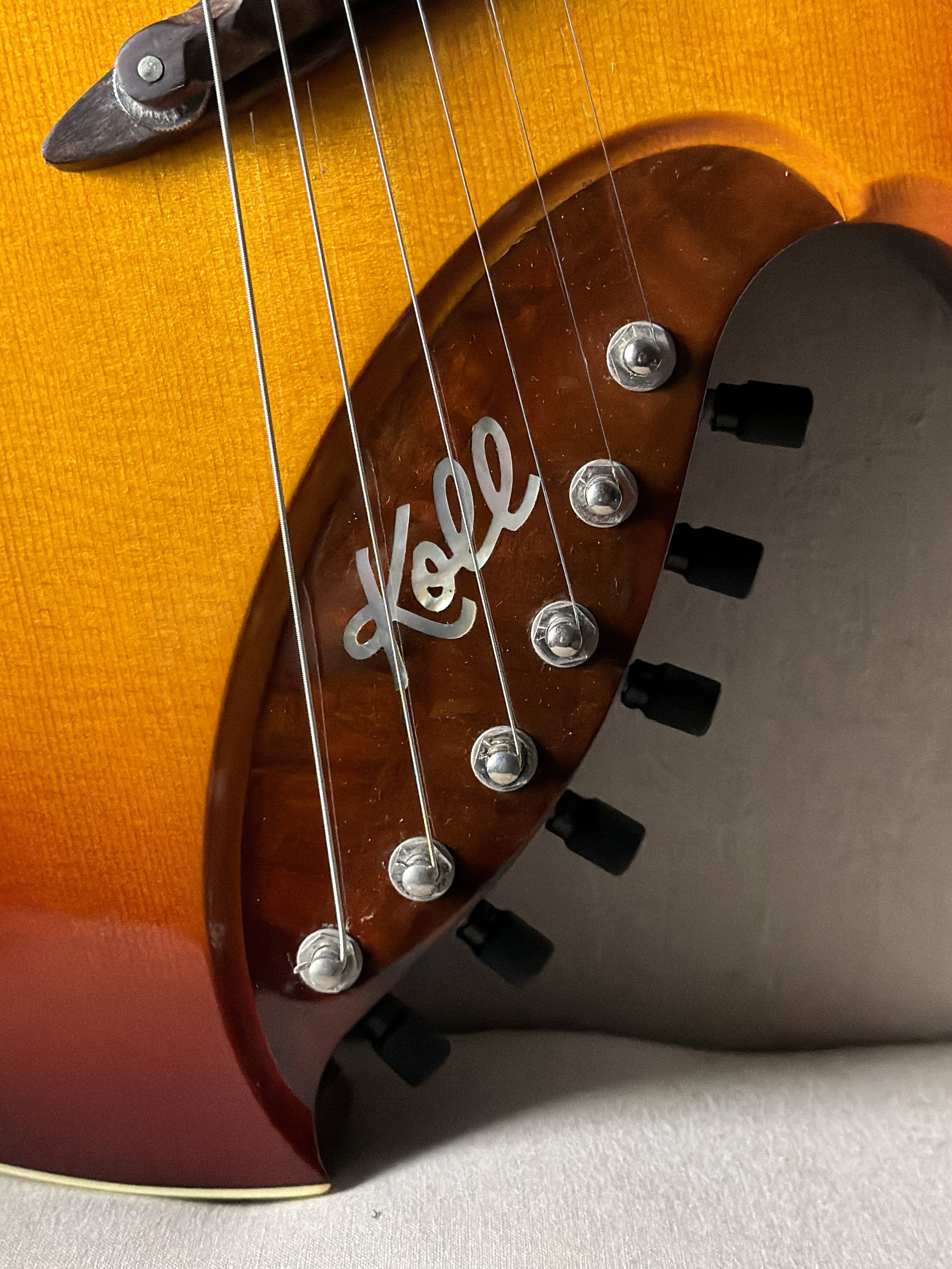Koll RE Archtop showing logo and tuners