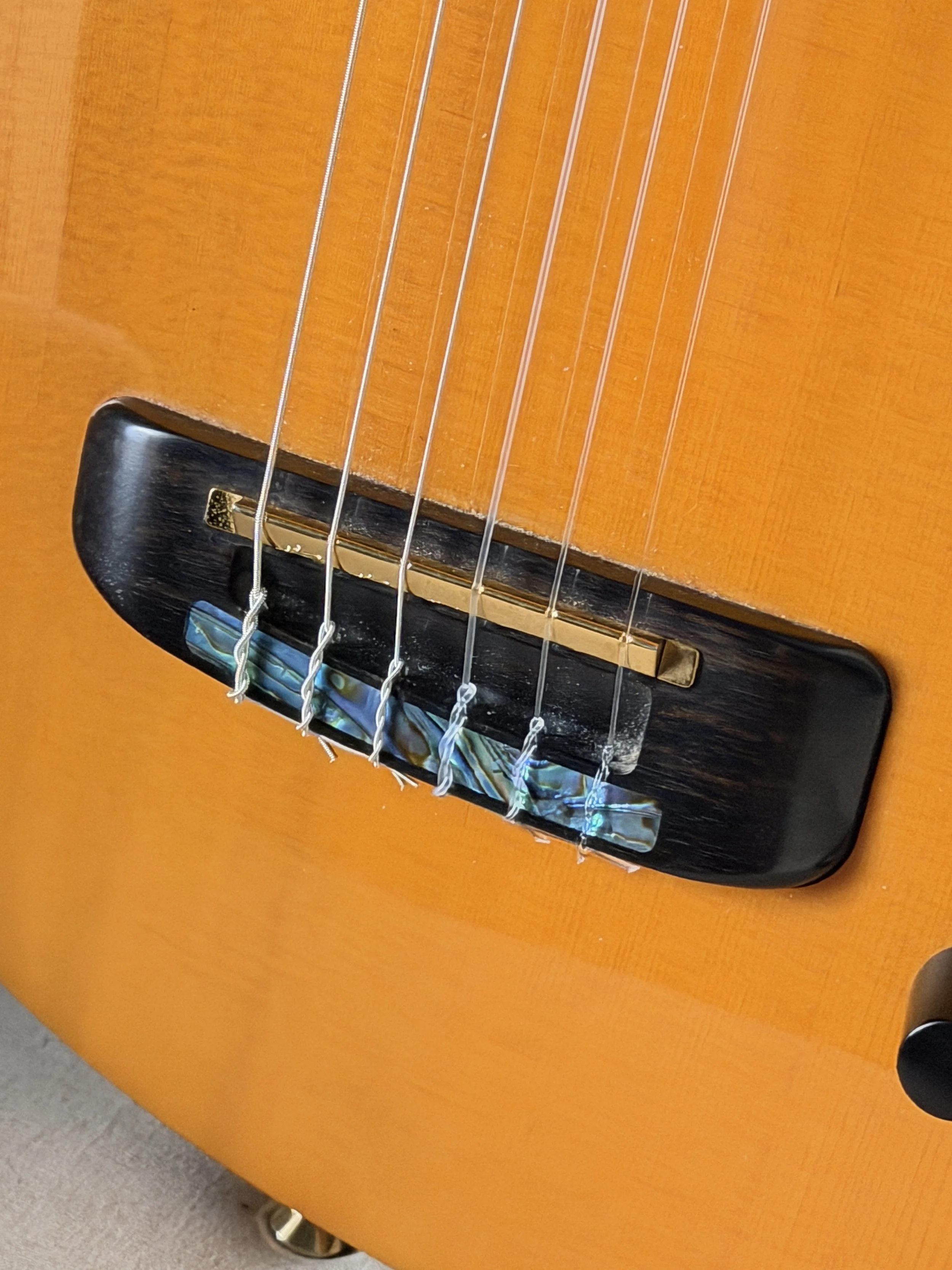 Parker Fly Nylon showing bridge with abalone inlay