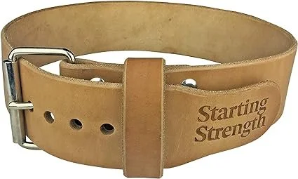A beige leather weightlifting belt with the words "Starting Strength" embroidered on it.