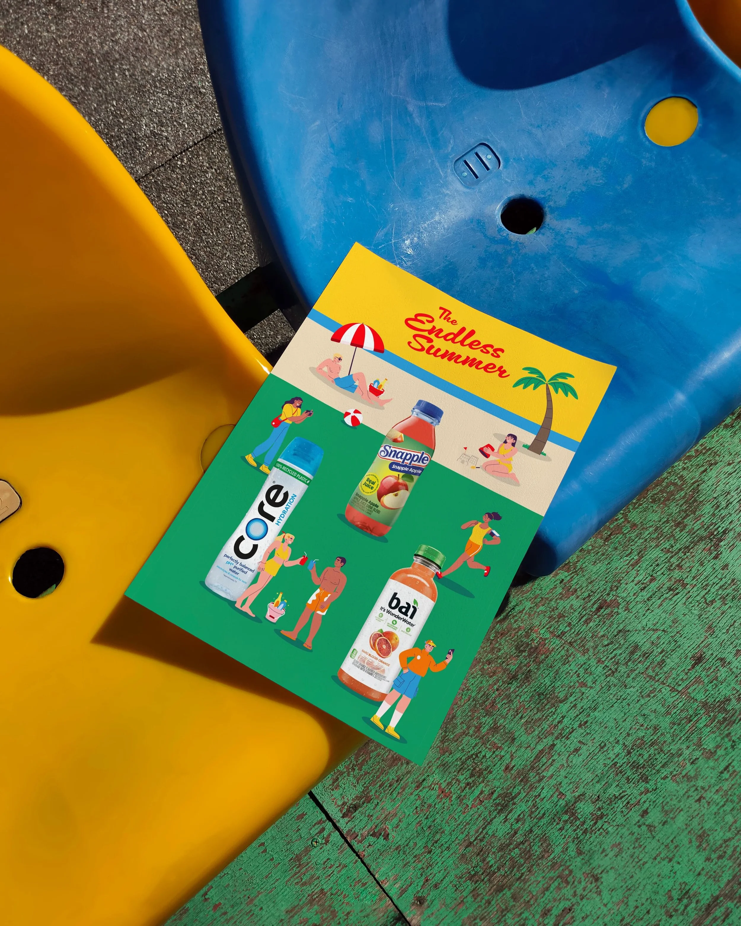 Close-up of a colorful flyer or brochure lying on a wooden surface next to yellow and blue plastic objects, depicting figures of people enjoying summer activities and various beverages.