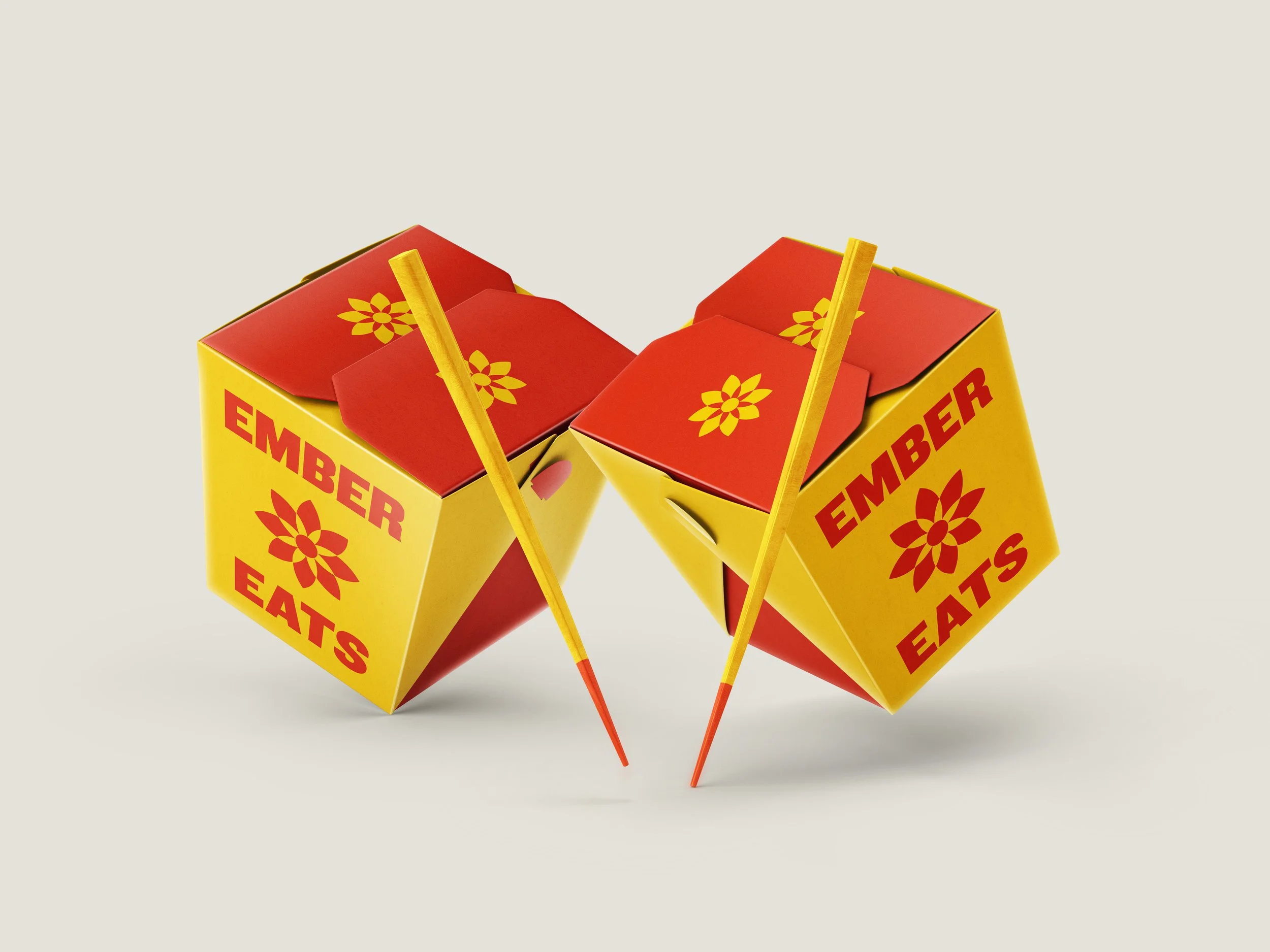 Three small yellow and red cardboard boxes of Chinese takeout food with orange sticks, with the word 'EMBER' visible on the boxes.