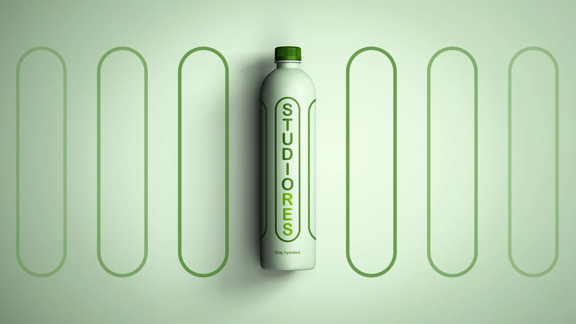 A light green water bottle with the word 'STUDIOS' written vertically in green on the front, standing against a matching green background with a pattern of elongated oval outlines.