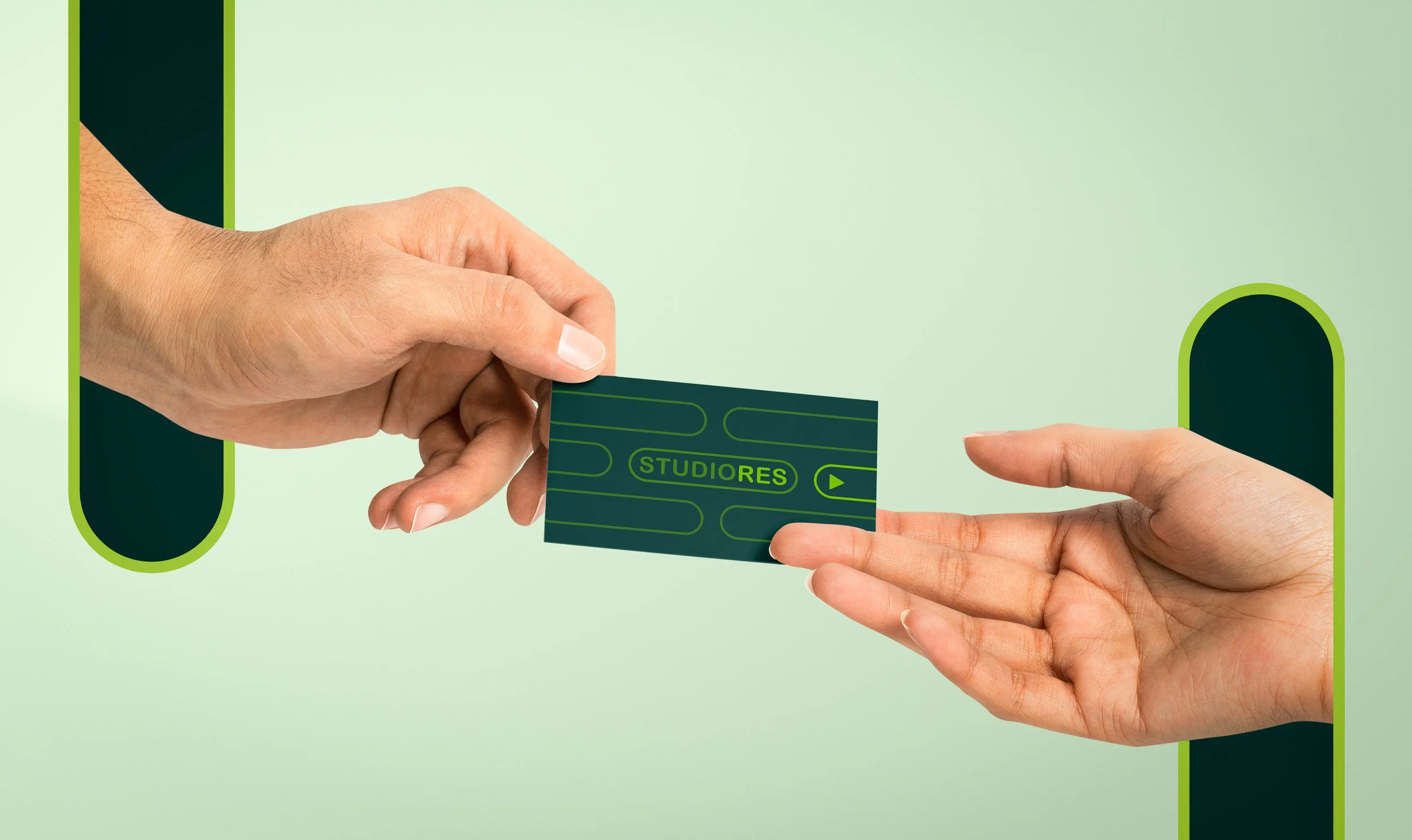Two hands exchanging a dark green ticket with green markings that read 'STUDIORES'.