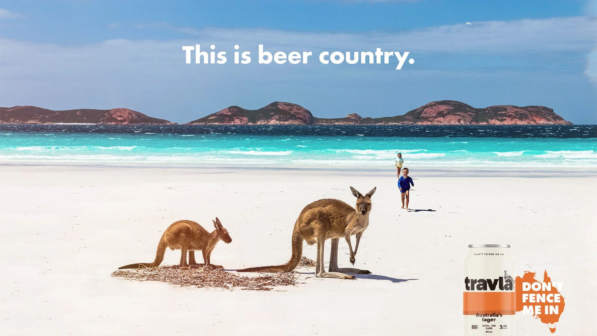 Beach scene with two kangaroos on white sand, two children walking in the background, ocean waves, and distant islands. The text 'This is beer country' and a Tralya beer advertisement with a can and the words 'Don't Fence Me In'.
