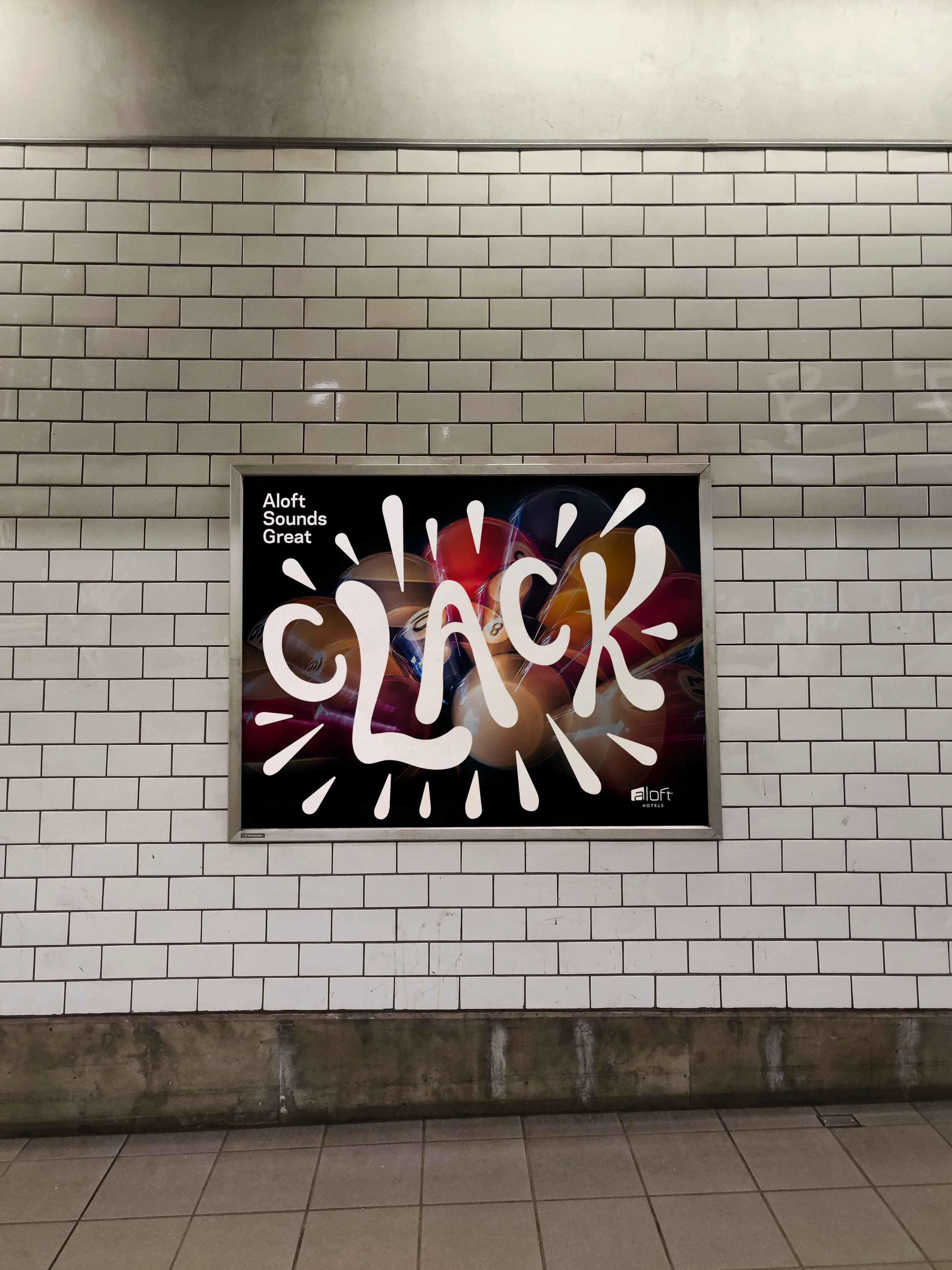 A poster on a white tiled wall with the word 'BLACK' in large, white, stylized letters, and the phrase 'Aloft Sounds Great' in the top left corner, featuring a background of colorful balloons.