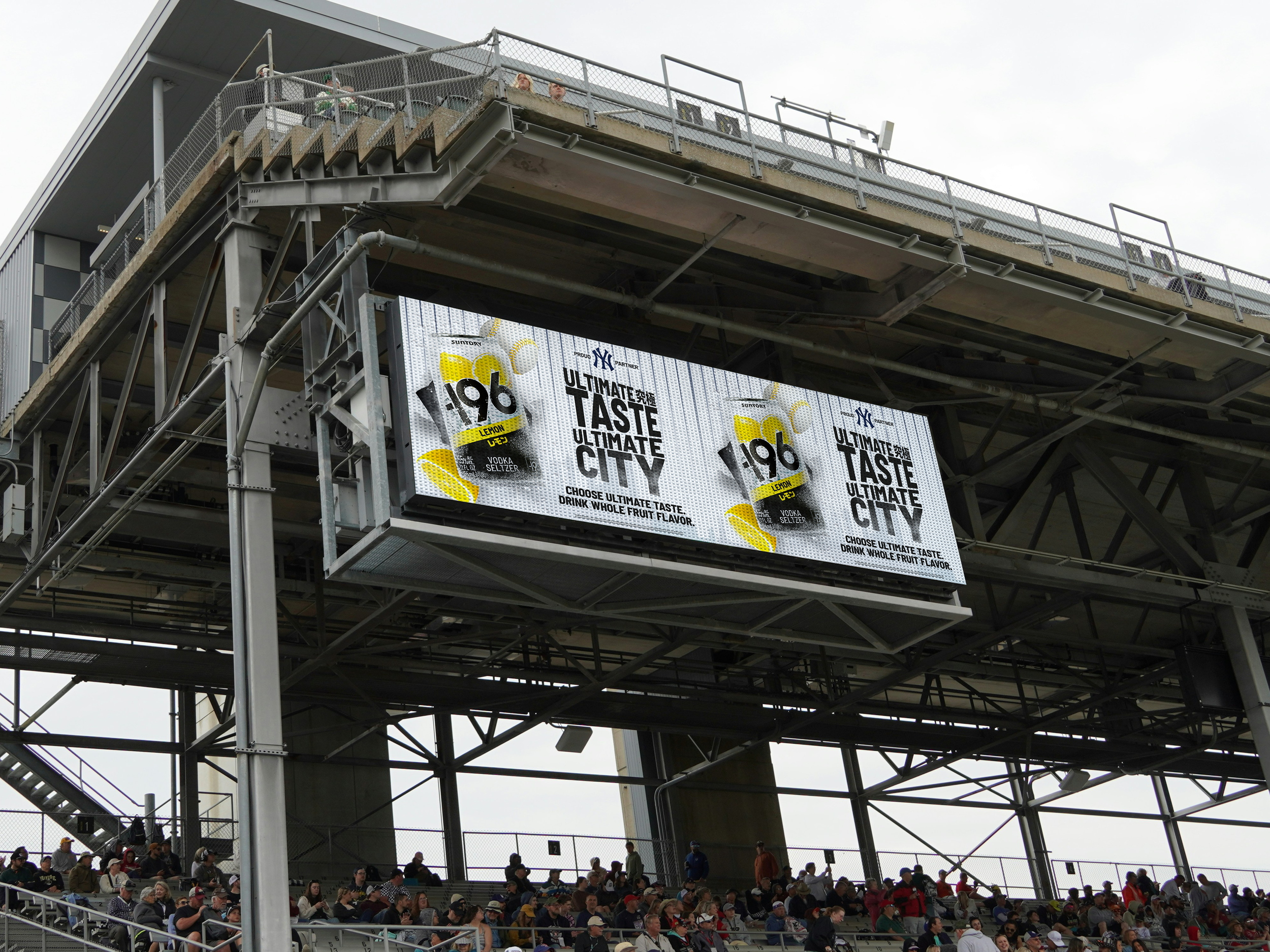 Billboard advertising a lemon-flavored vodka, with the text "Ultimate Taste, Ultimate City," below the image of a bottle and lemon slices, and a crowd of spectators sitting at a sports stadium.