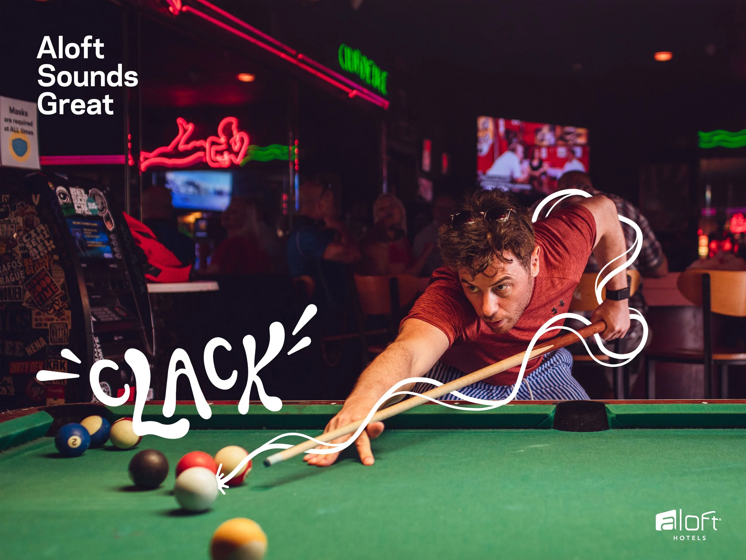 A man playing pool in a bar, aimed at the cue ball with focus. Neon signs and other patrons in the background. The words 'Aloft Sounds Great' and 'LUCK' are superimposed on the image.