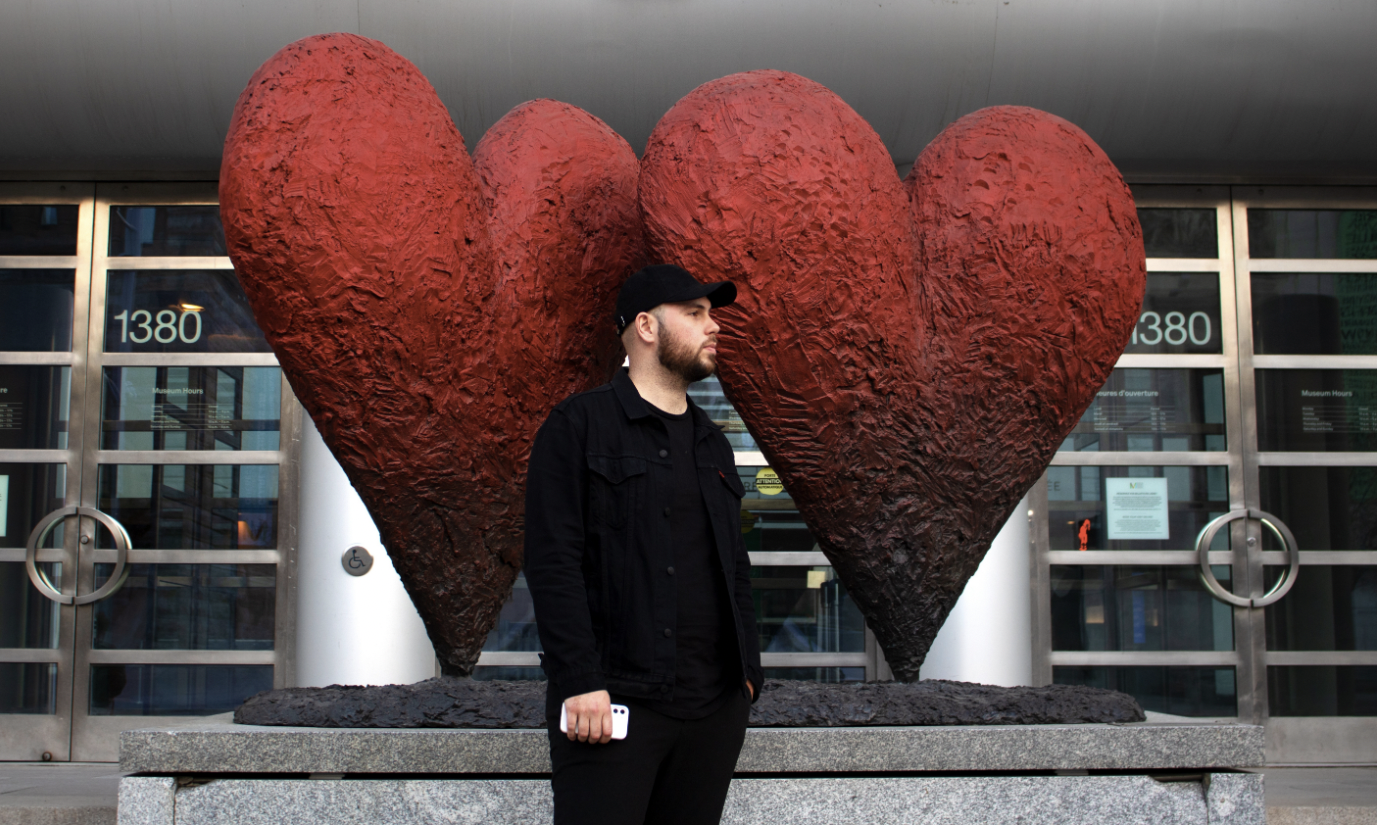 Djawad Dib waits for his friends in front of the Montreal Museum of Fine Arts.