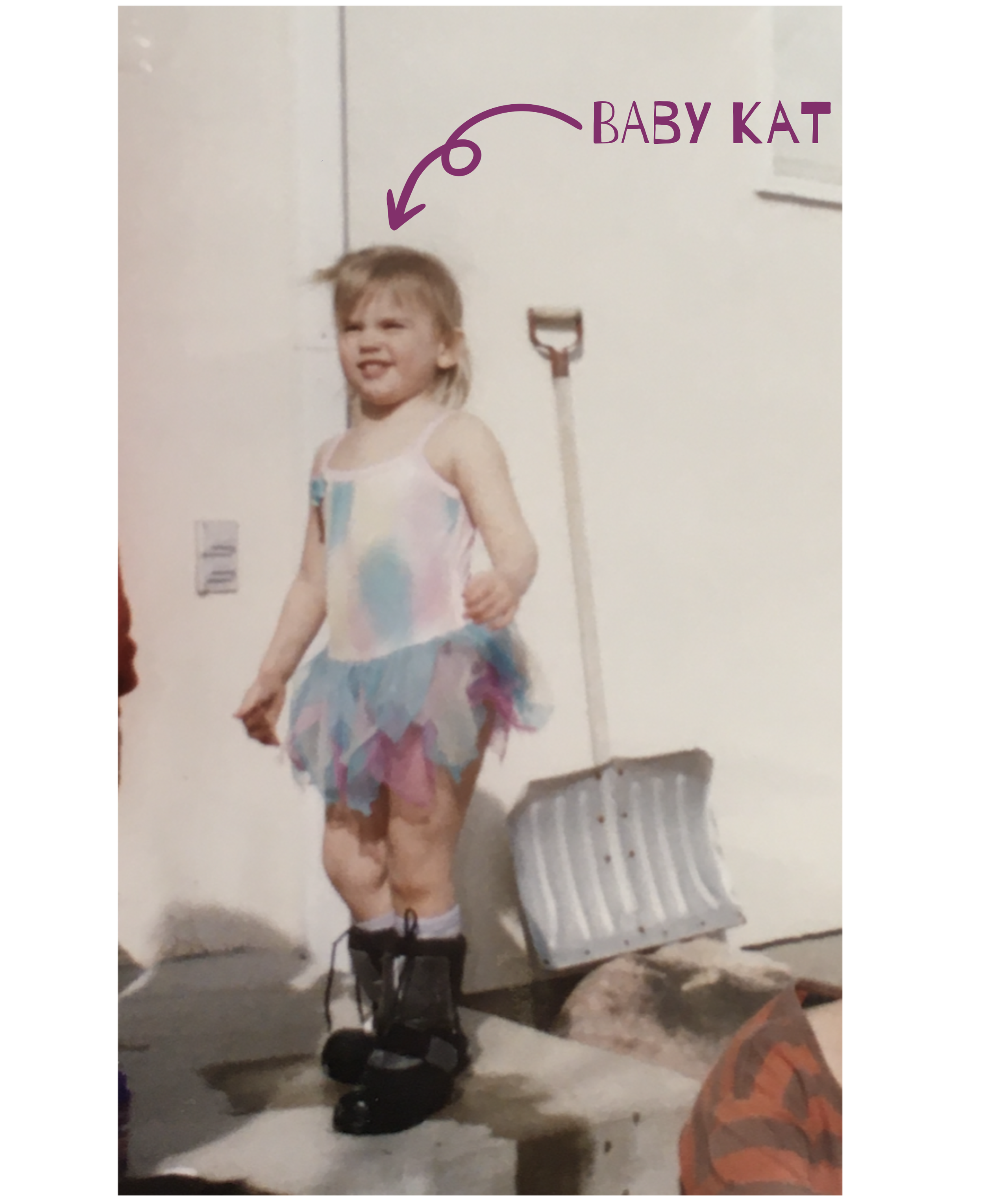 Young Kat stands squinting in the sun on a front stoop, wearing big black boots and a pink, purple, and blue leotard with a tutu. A snow shovel sits behind them, and an arrow points to their face labeled “baby Kat.”