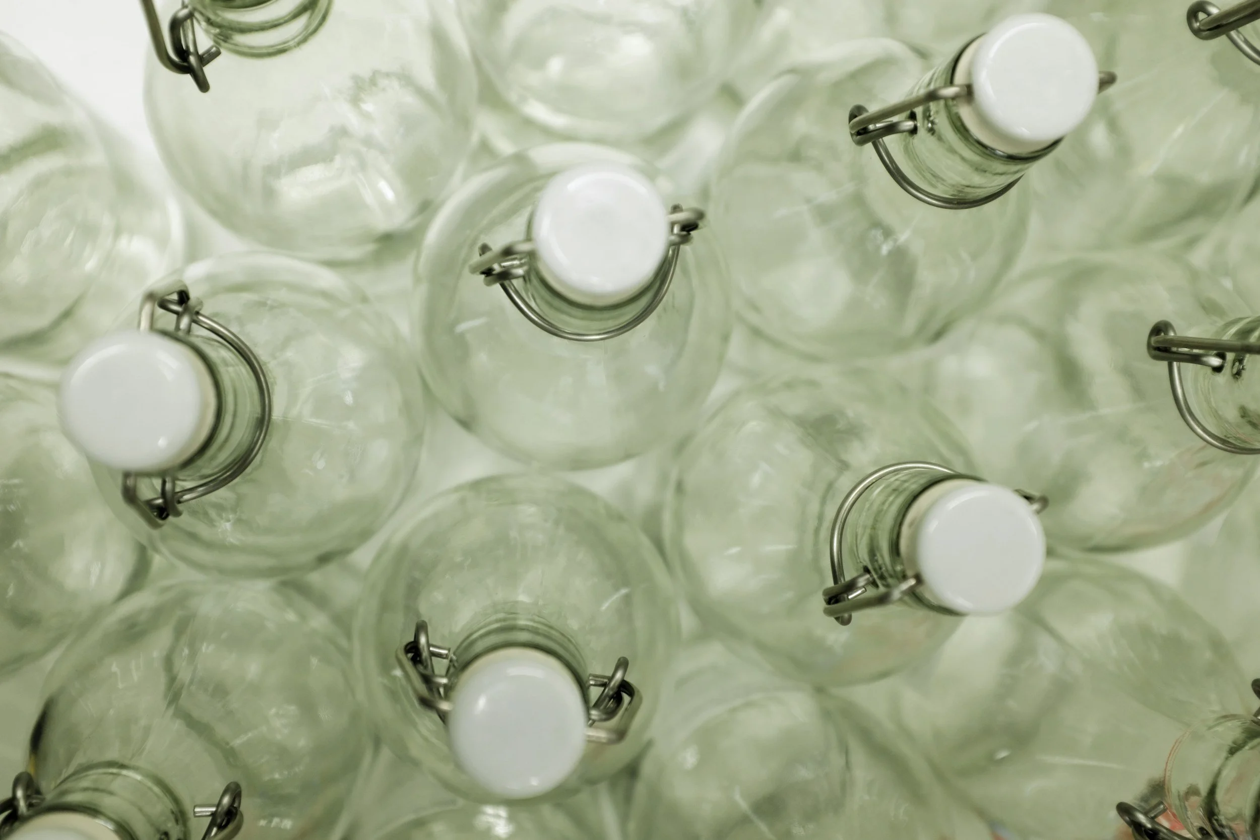Top view of empty glass bottles with swing top lids