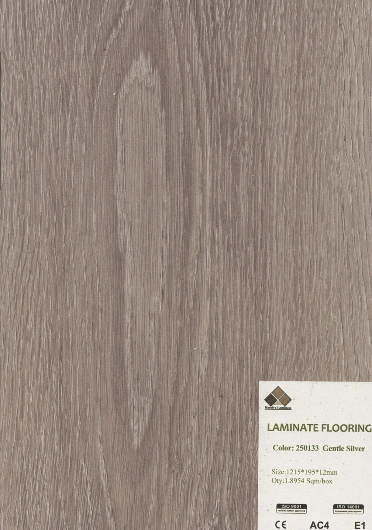 Close-up of a wood laminate flooring sample in a gentle silver color with a visible grain pattern.