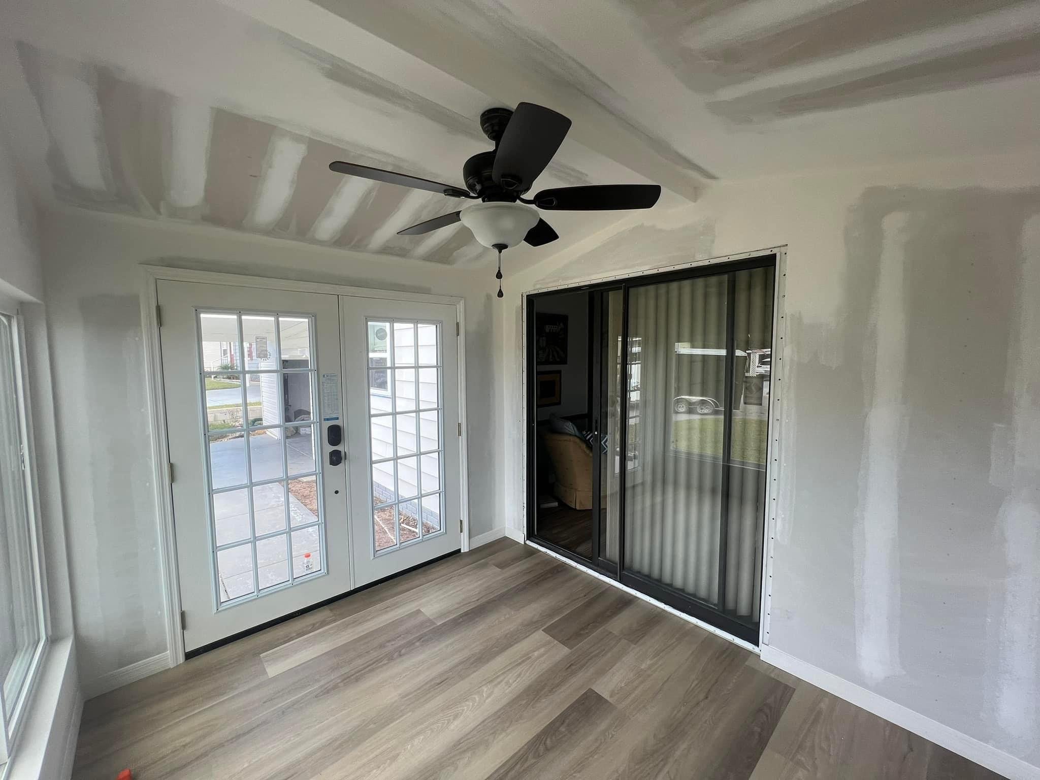 Sunroom Complete Remodel, new flooring, windows, and French doors.