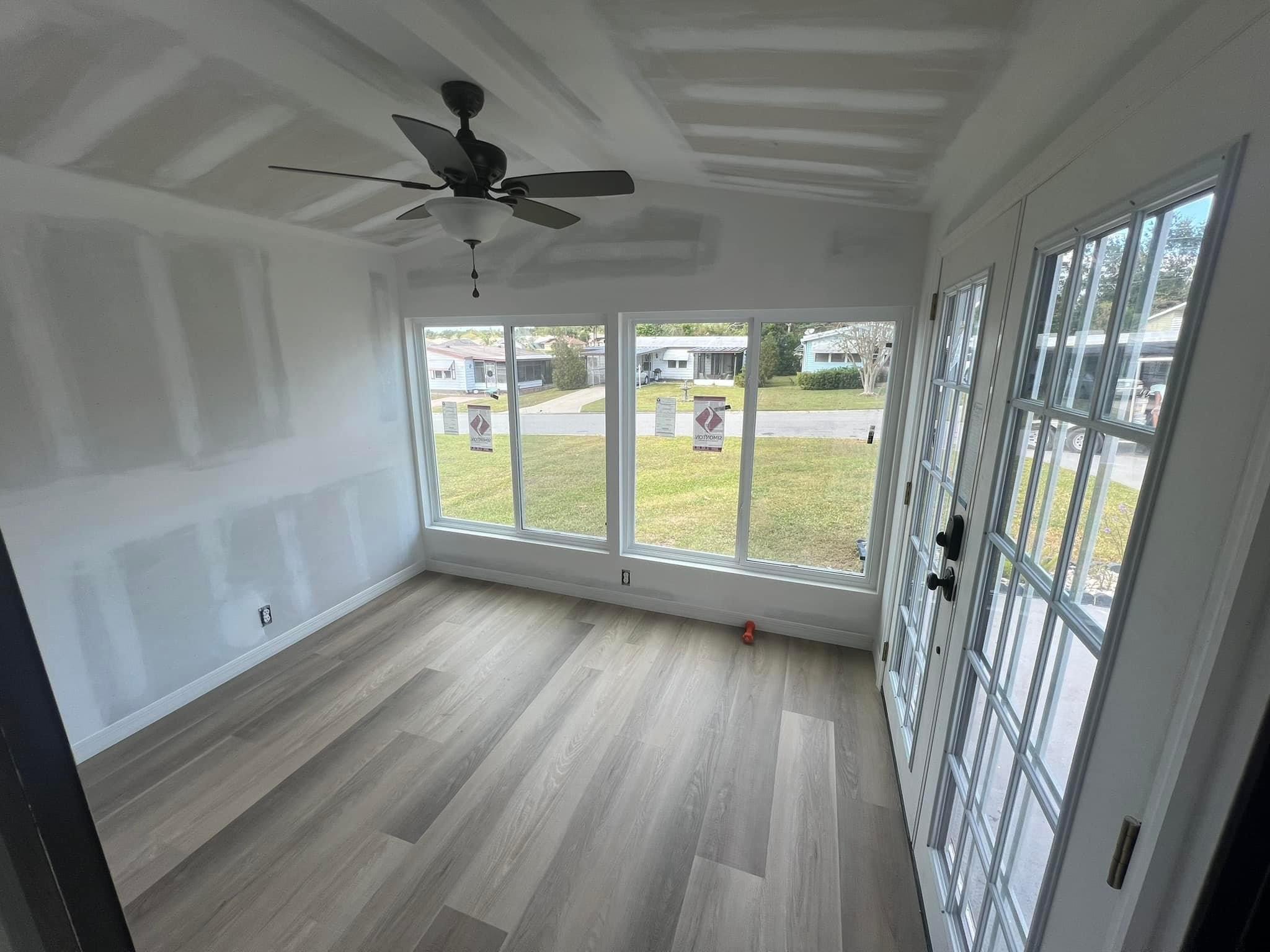 Sunroom Complete Remodel, new flooring, windows, and French doors.