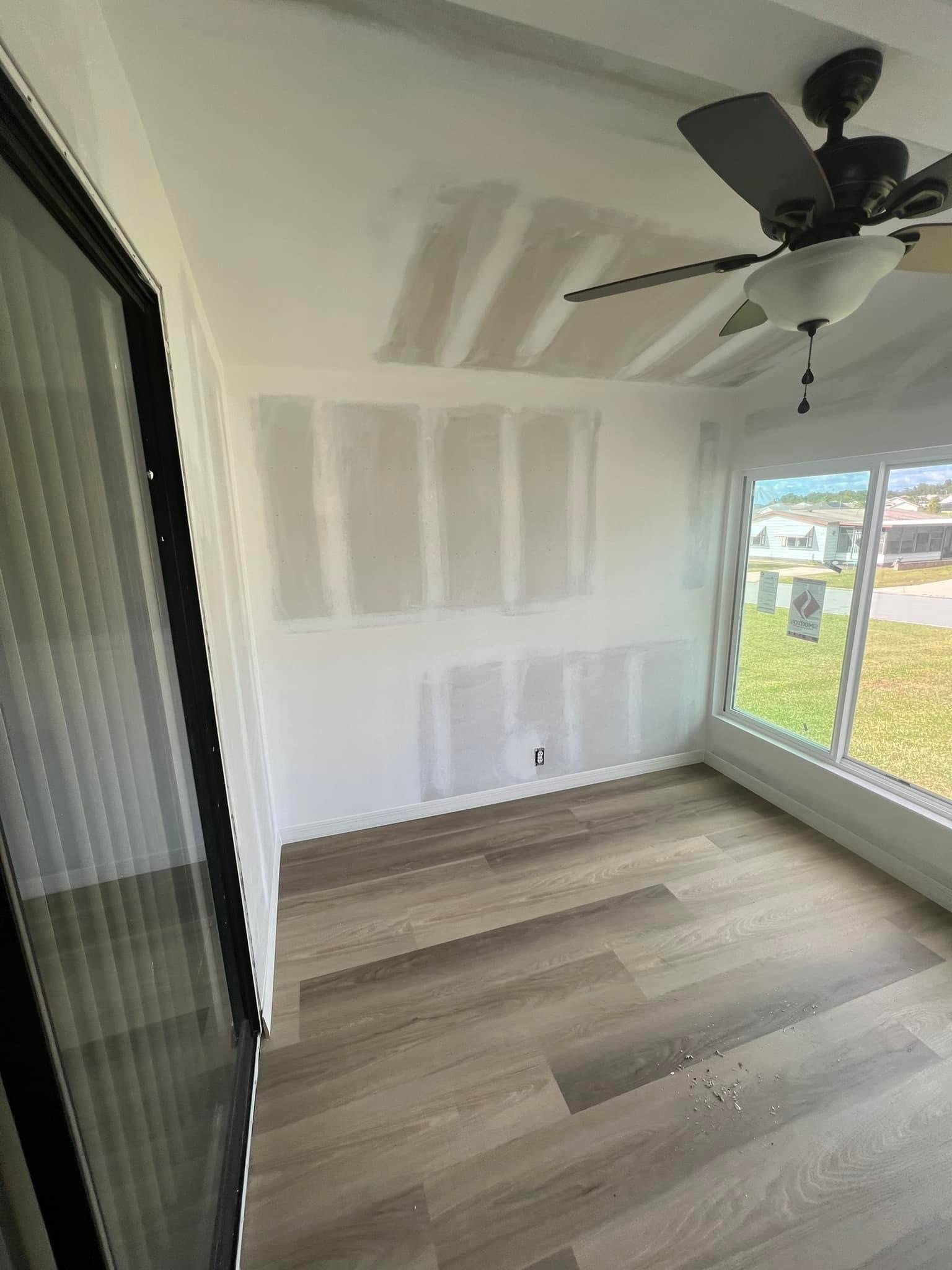 Sunroom Complete Remodel, new flooring, windows, and French doors.
