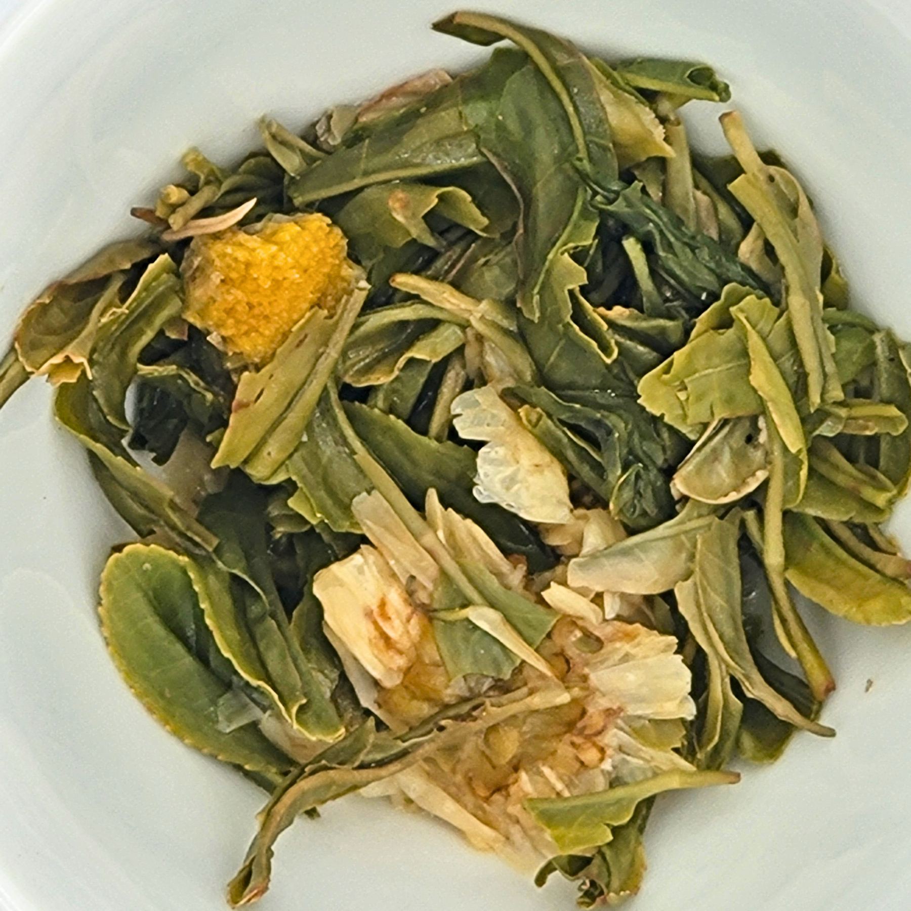 Close up of brewed Chrysanthemum Joonjak tea leaves.