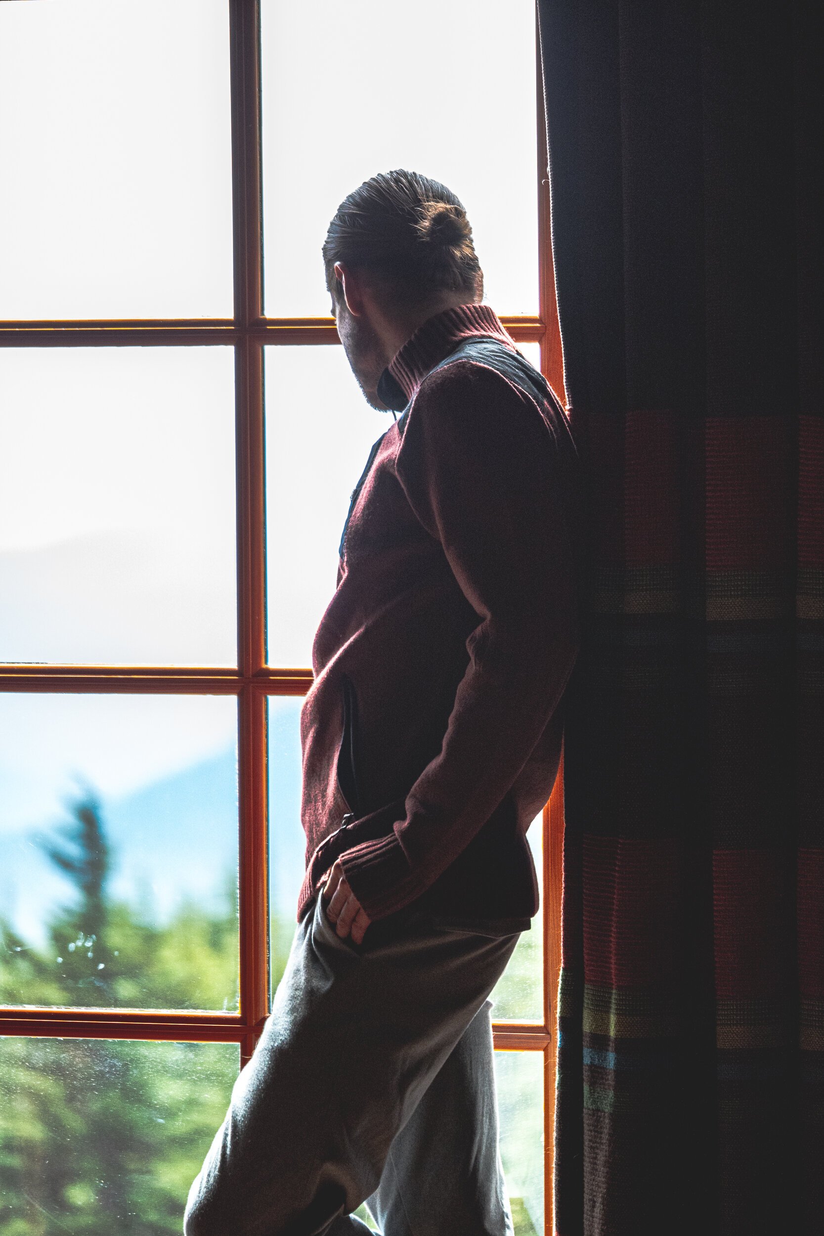 man looking out window fashion
