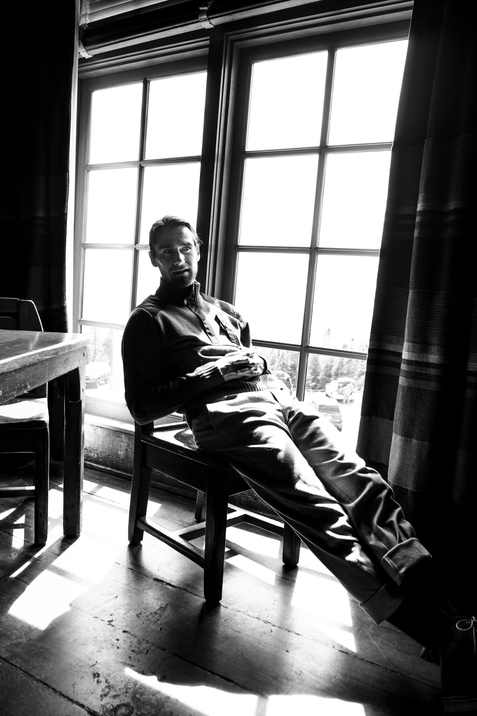 black and white man against window
