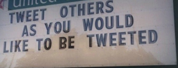 A sign with the message 'Tweet others as you would like to be tweeted,' encouraging positive social media behavior.