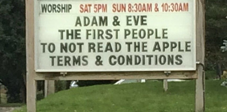 A church sign advertising worship times and humorously claiming that Adam and Eve were the first people to not read the Apple Terms and Conditions.