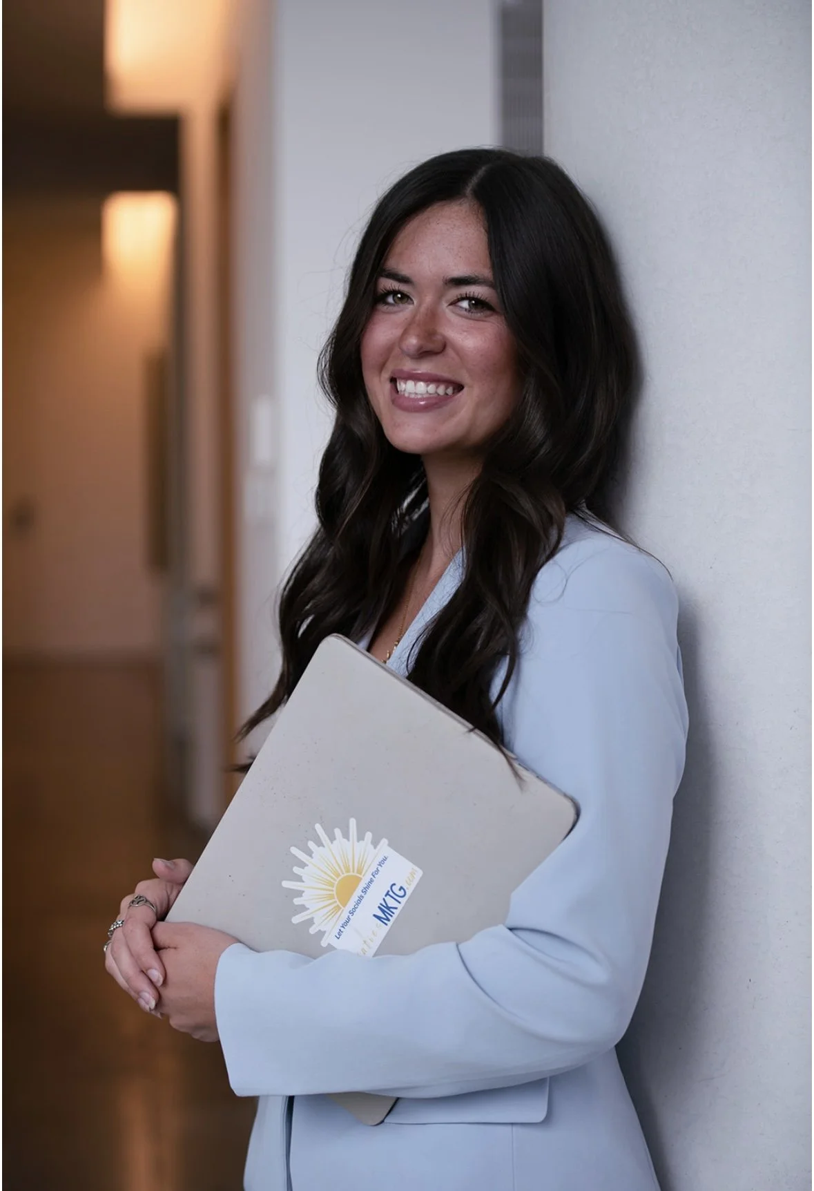Digital marketing strategist, holding laptop while working with clients in Richmond VA