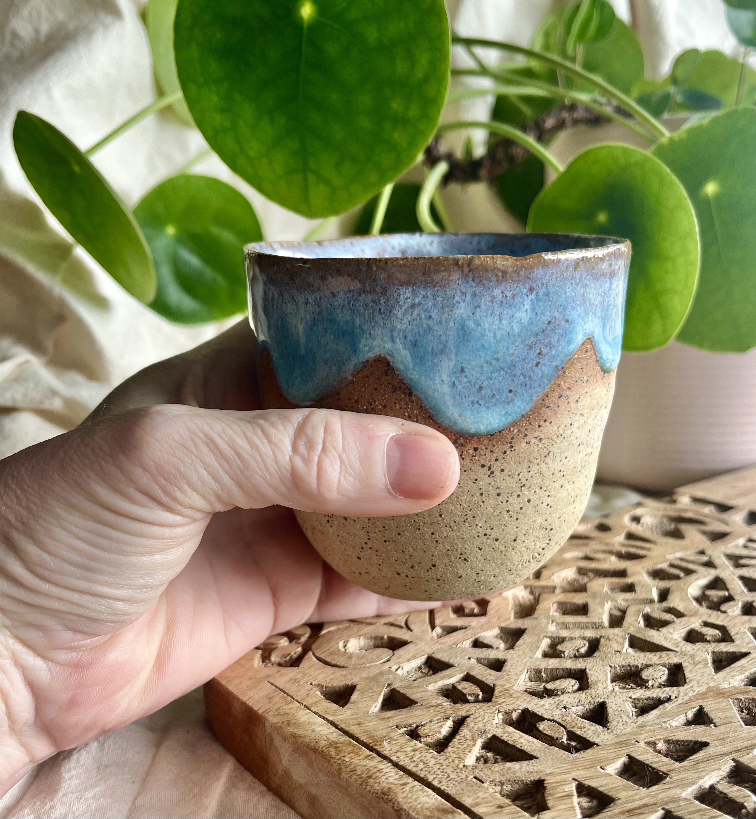 Light blue scalloped cup in hand view.jpeg