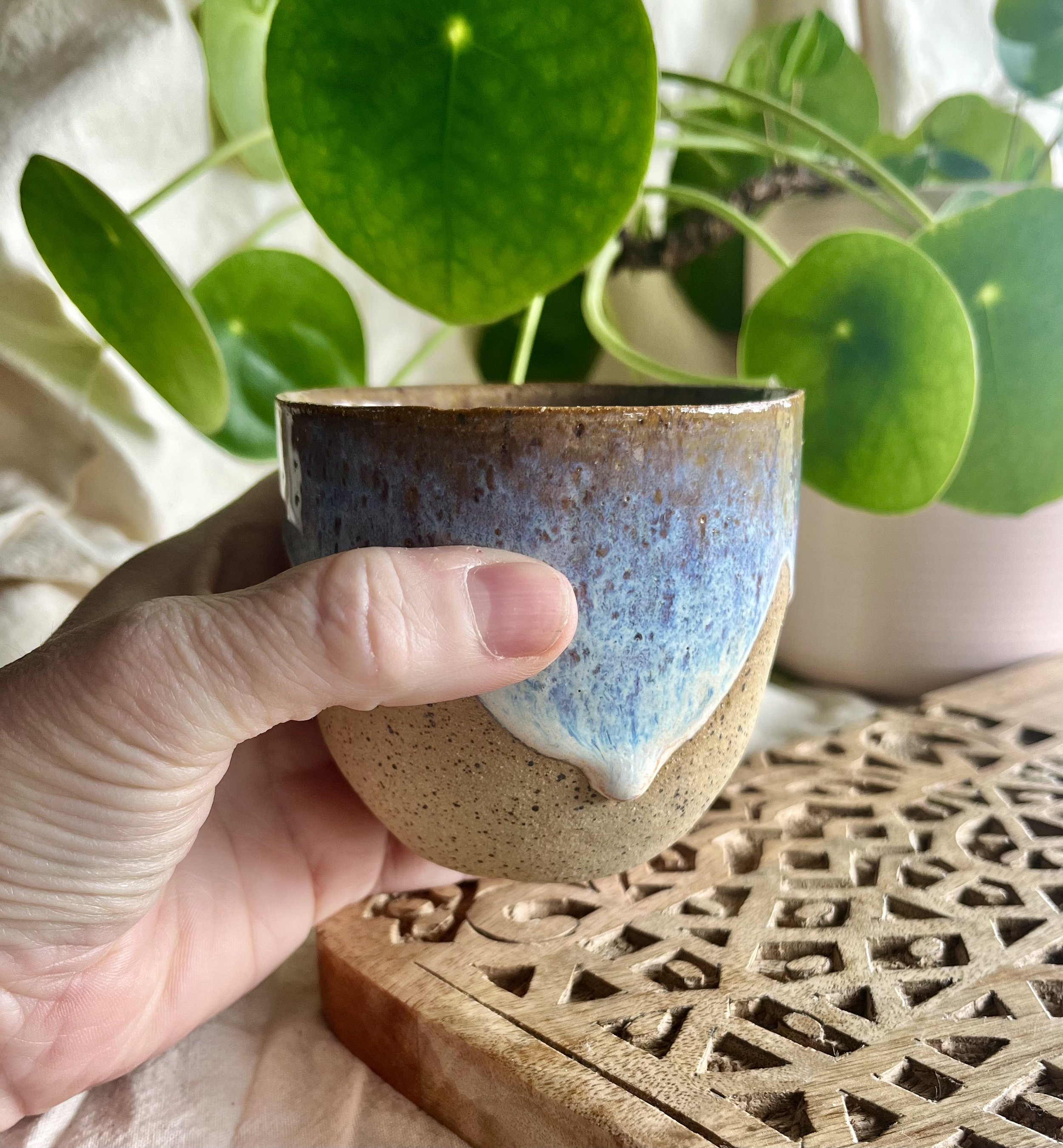 blue and cream scalloped cup in hand view.jpeg