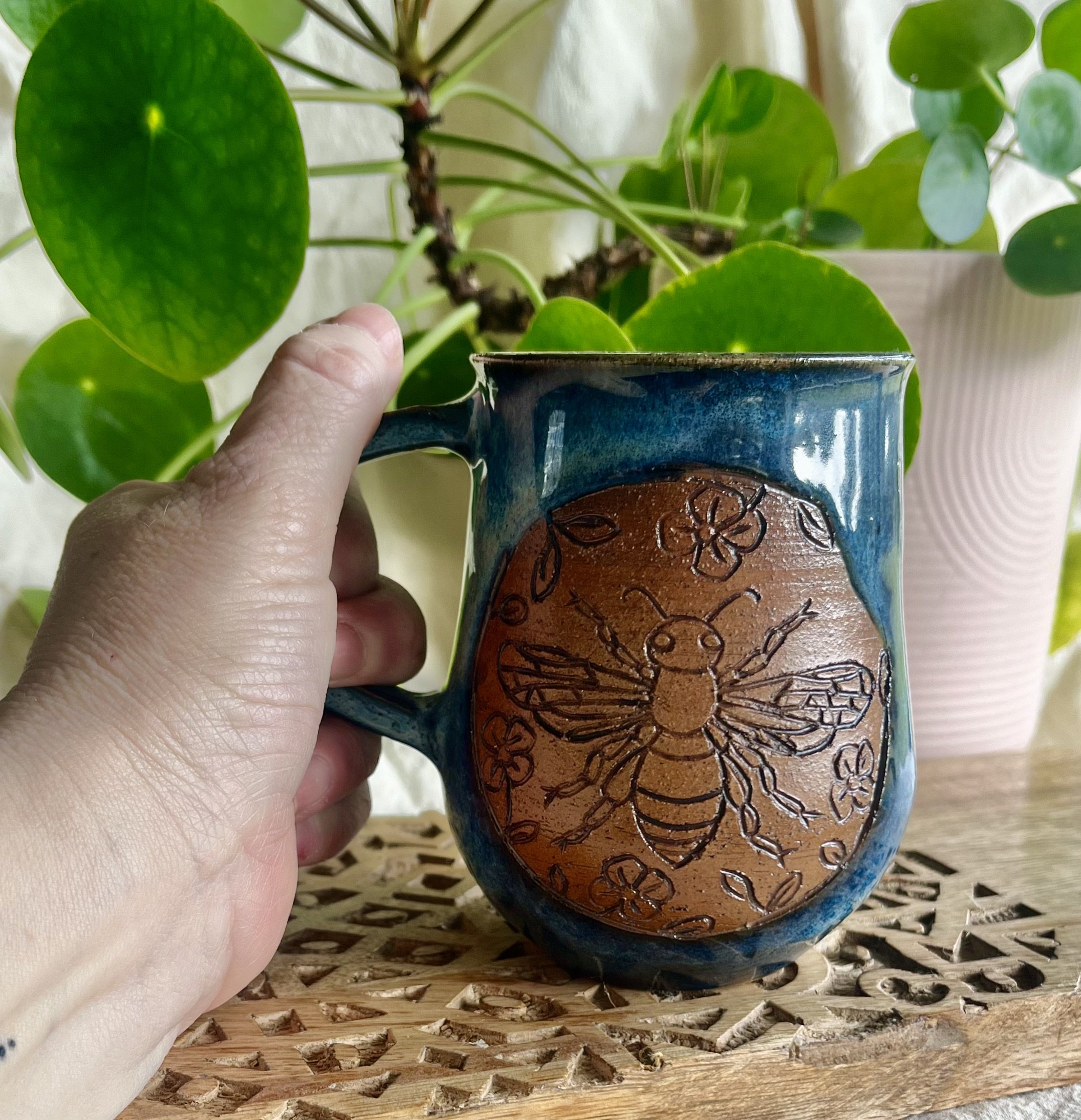 Midnight blue bee mug in hand view.jpeg